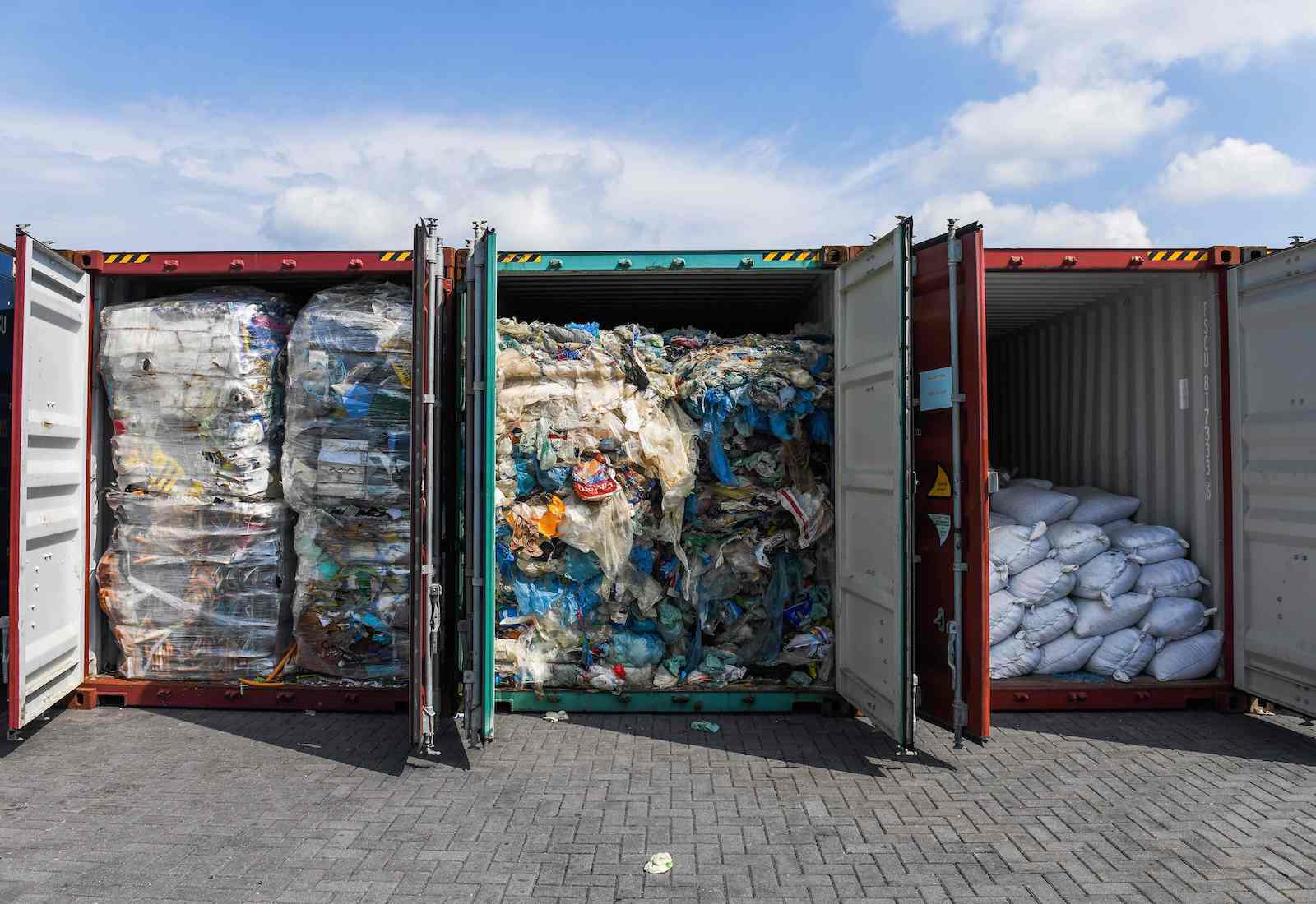 Three containers filled with plastic waste