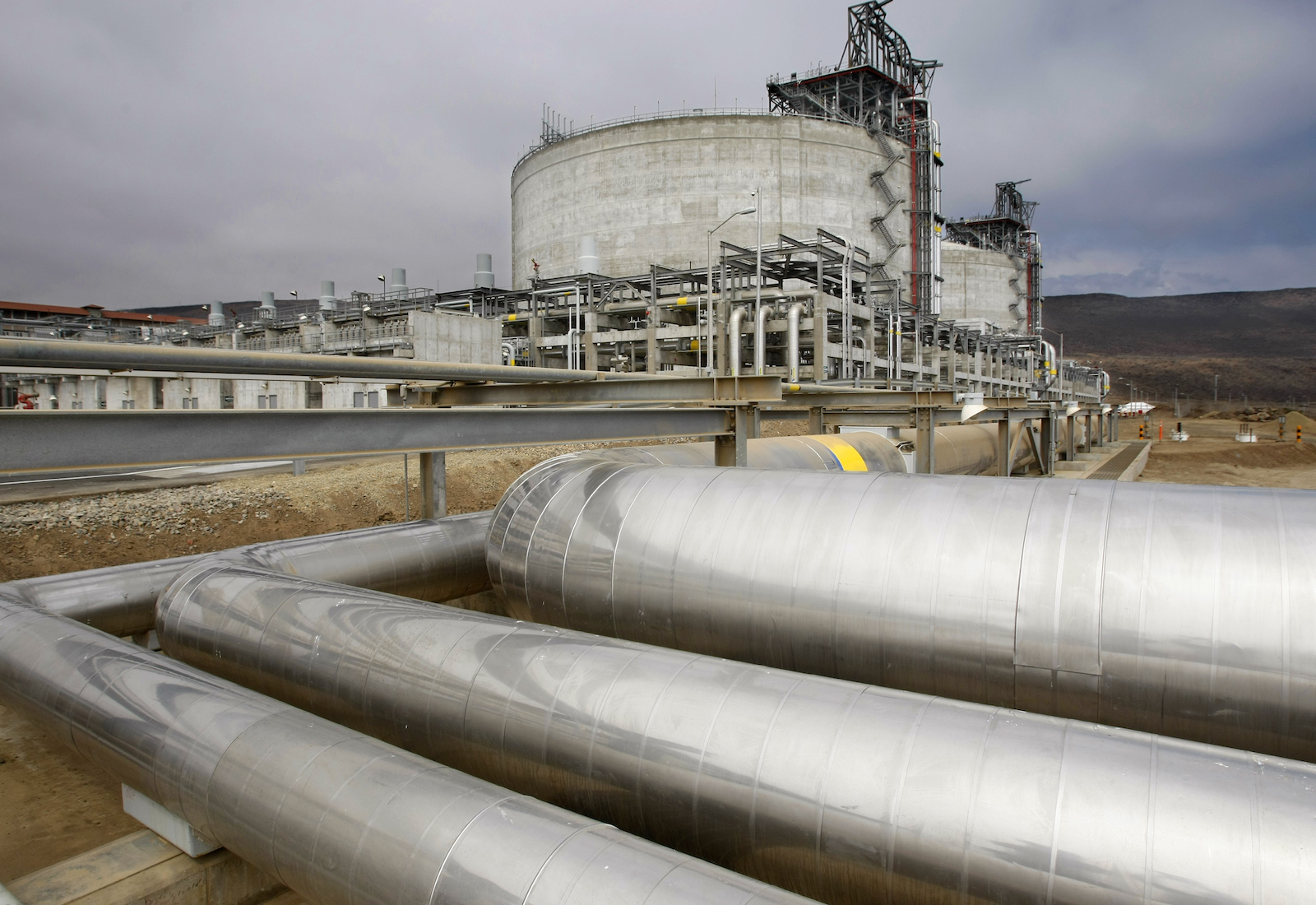 Insulated natural gas pipes with a factory in the background