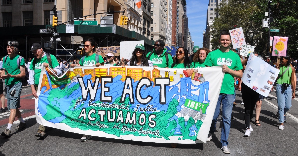 Protestors march holding a sign that reads 