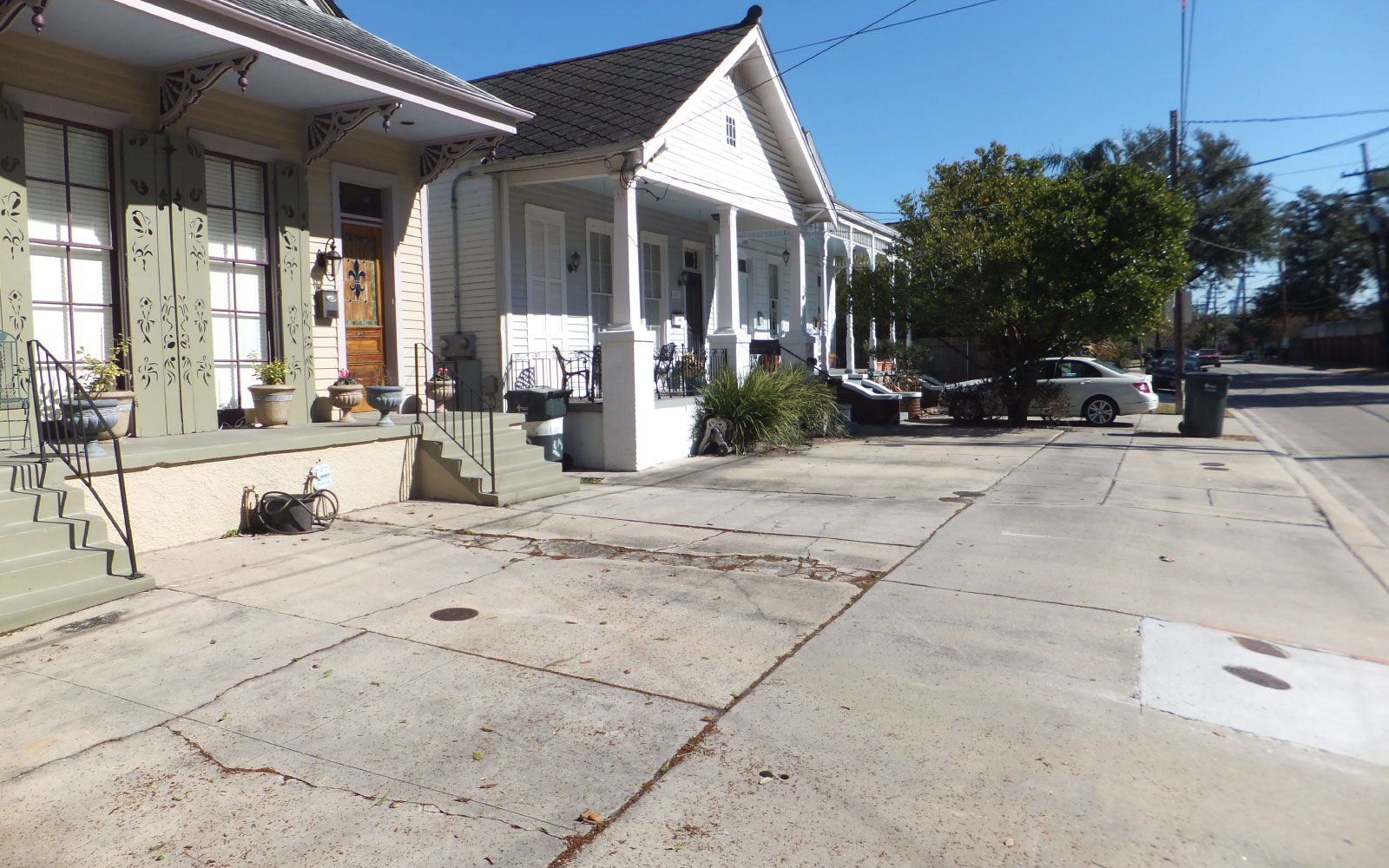 Wide concrete sidewalks stretching from front porches to the asphalt street