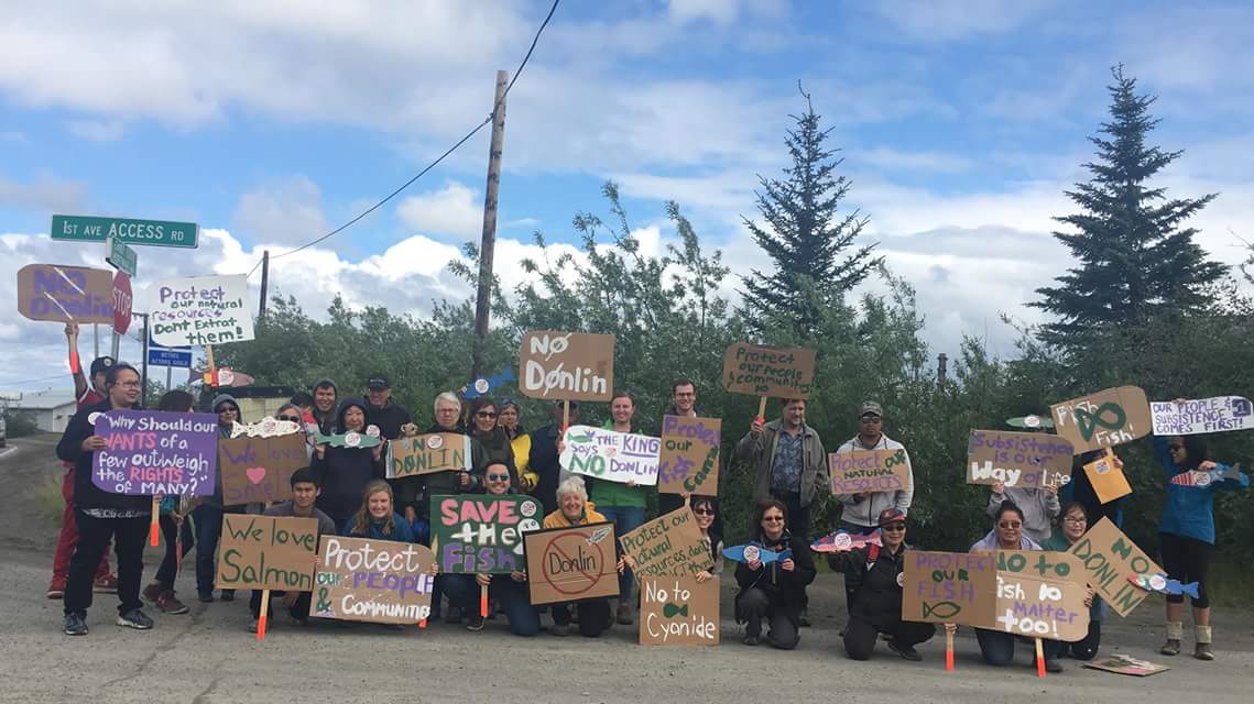 a group of people hold signs with various 'no donlin' messages