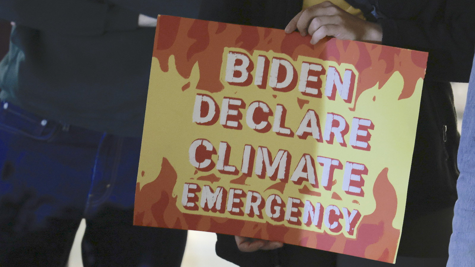 A protester holds a sign saying 