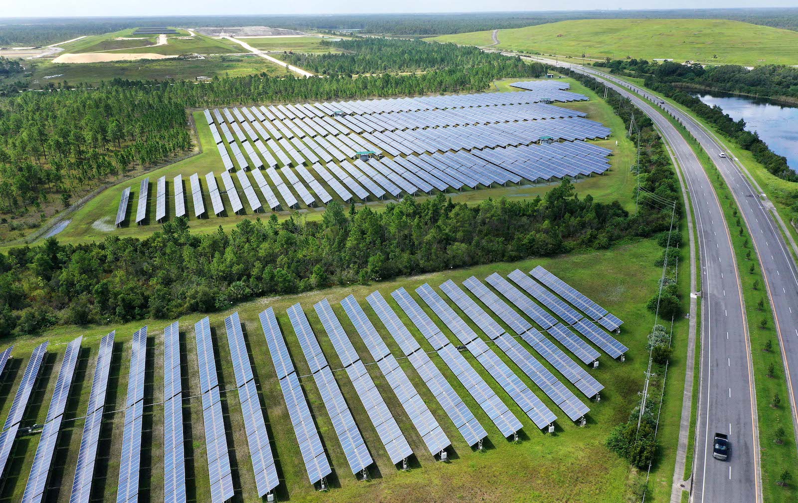 aerial view of a solar farm with a paved road to the right