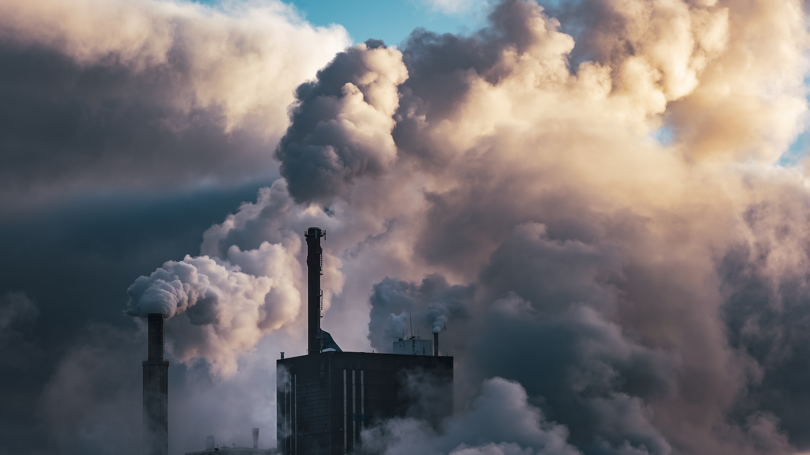 Smoke billows from a factory