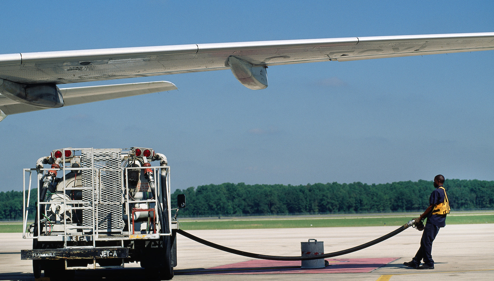 Jet-A1 refuelling bowser parked under an Airbus A320 left wing.