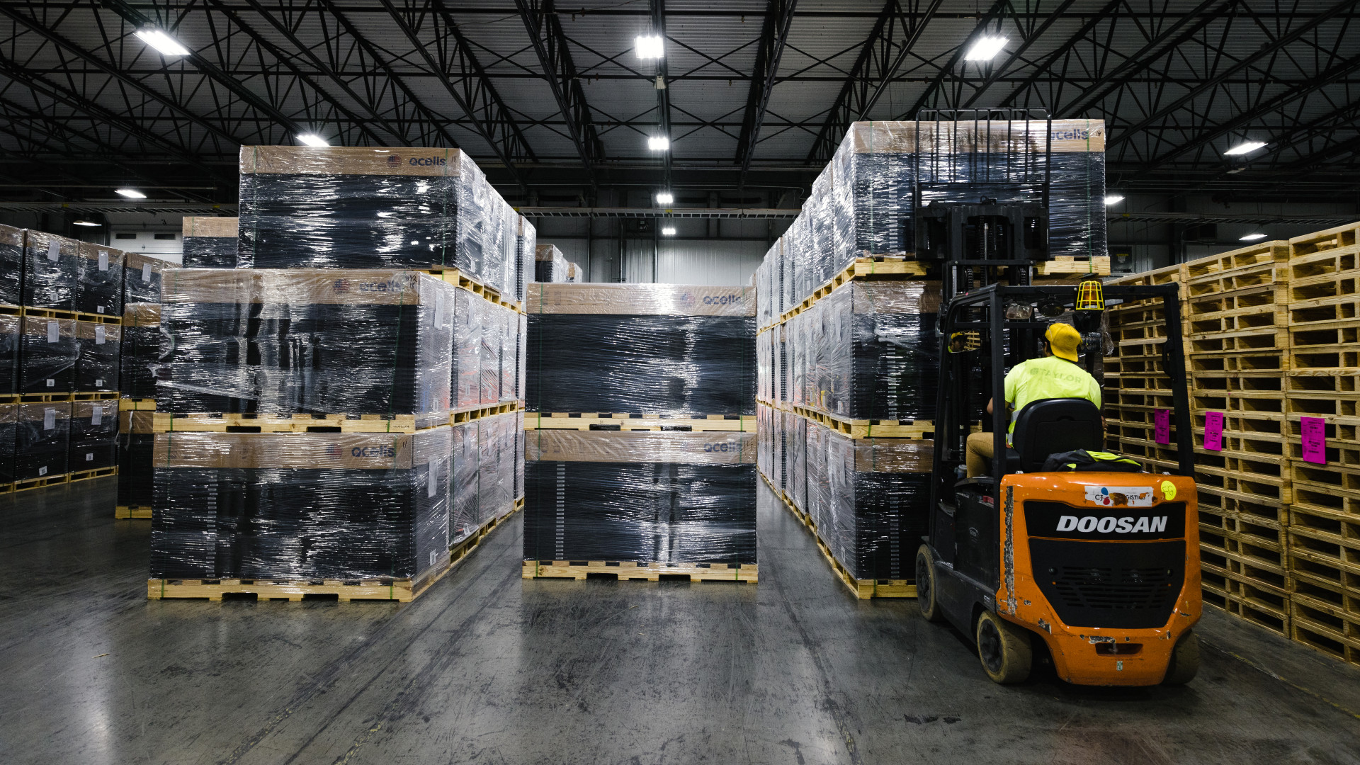 A worker moves stacks of completed solar panels ready for shipping on the assembly floor at the Qcells solar panel manufacturing facility in Dalton, Georgia. China's dominance over solar manufacturing leaves America in a vulnerable place. Now, U.S. firms are racing to revive this idled industry at home. At the center of this movement is a plant in Dalton, Georgia where solar panels are made. It is one of the only places in the US where this is happening. Is this plant an example of what is coming in the US or a vestige of a bygone manufacturing era? The stakes are high. If the U.S. can't figure out how to bring some of this supply chain back home, it could find itself boxed out of the market for the solar panels and cells desperately needed for the energy transition.