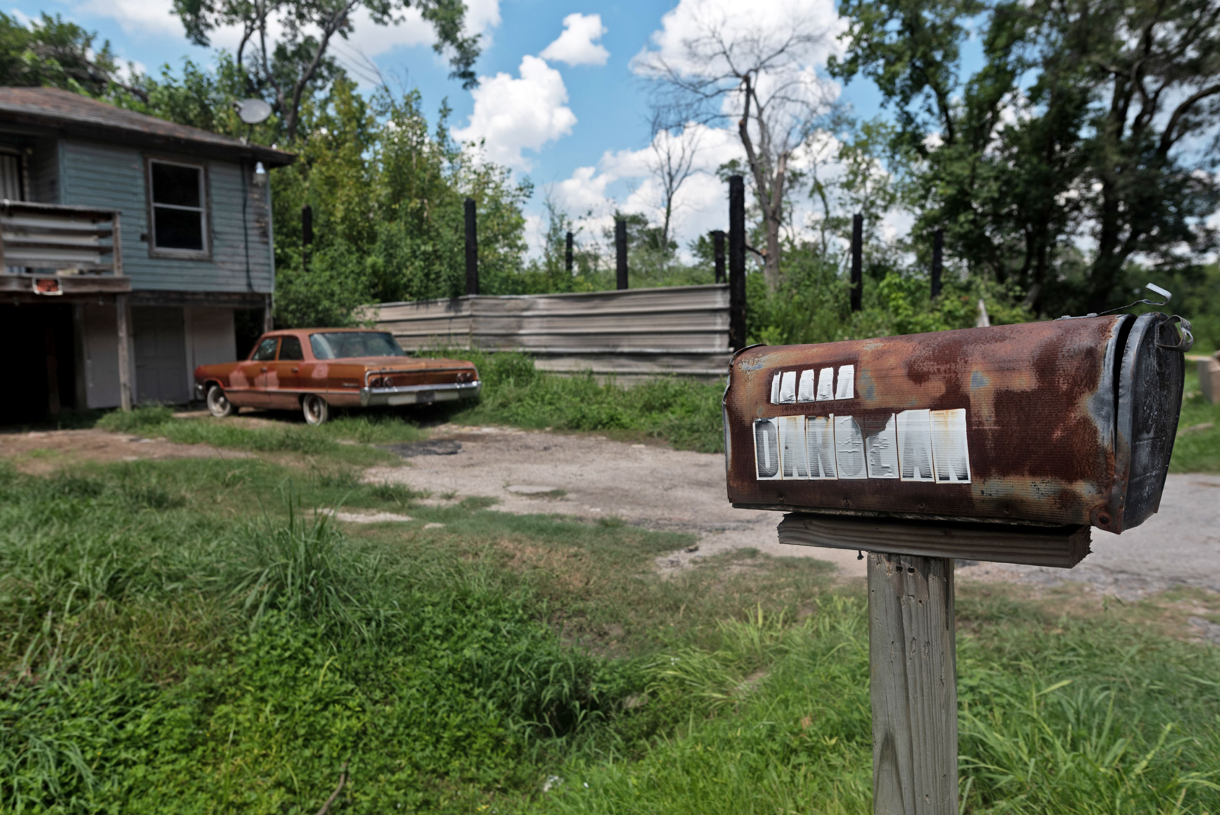 A rusty mailbox with the faded word 