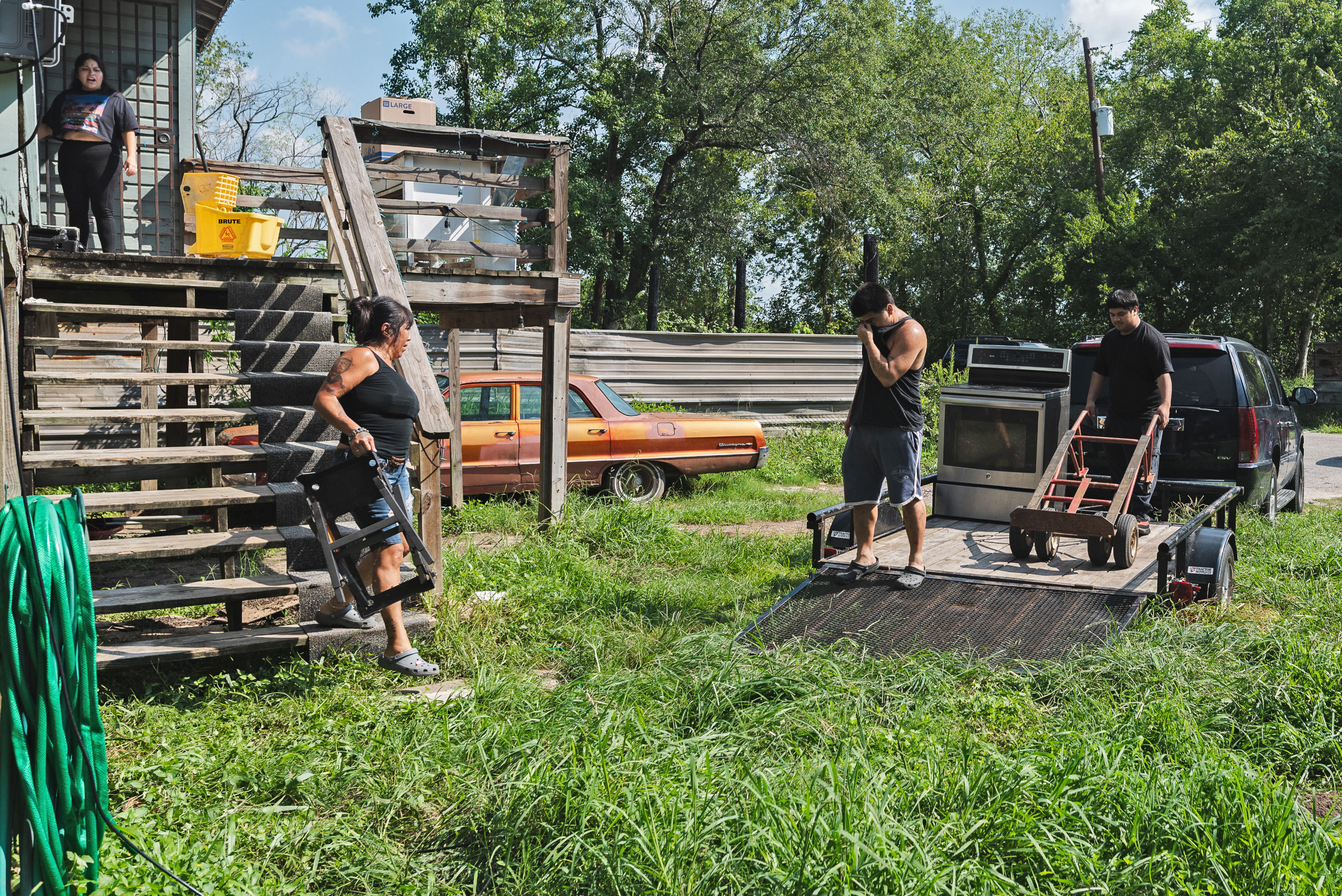 People loading their belongings onto a truck as part of a buyout.