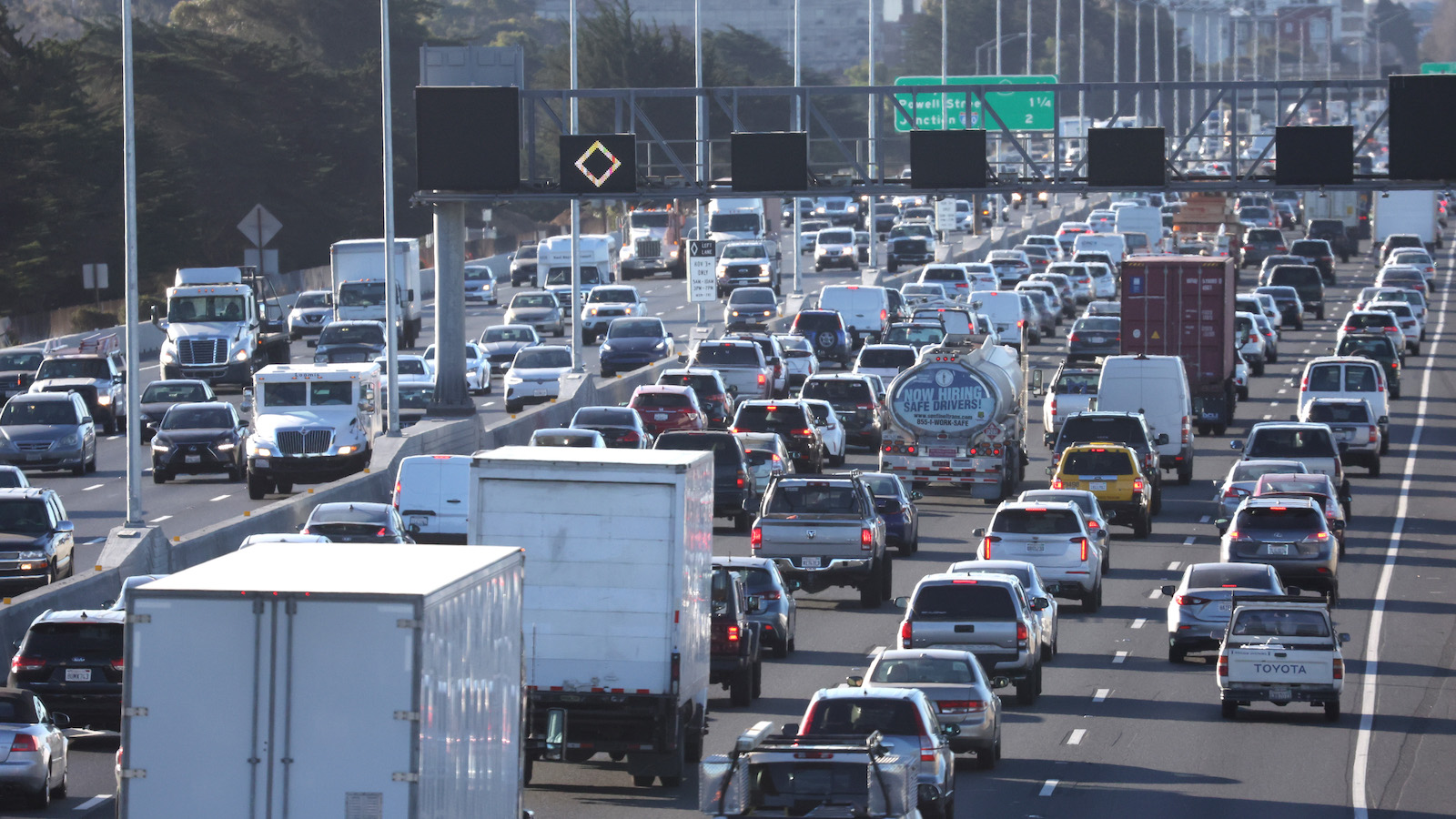 Cars lined up in traffic on a highway