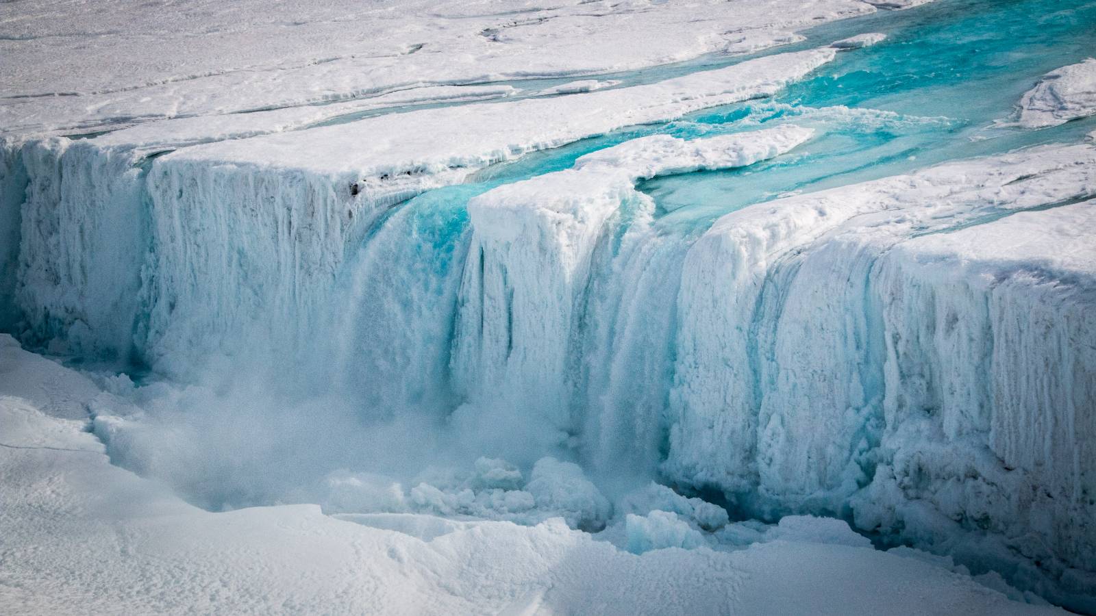 an ice sheet melting that looks like a waterfall