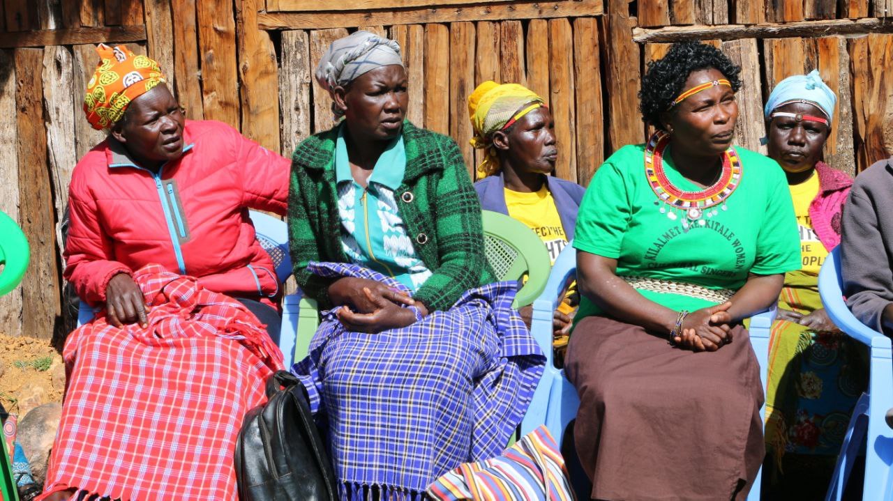 Five women sitting and listening