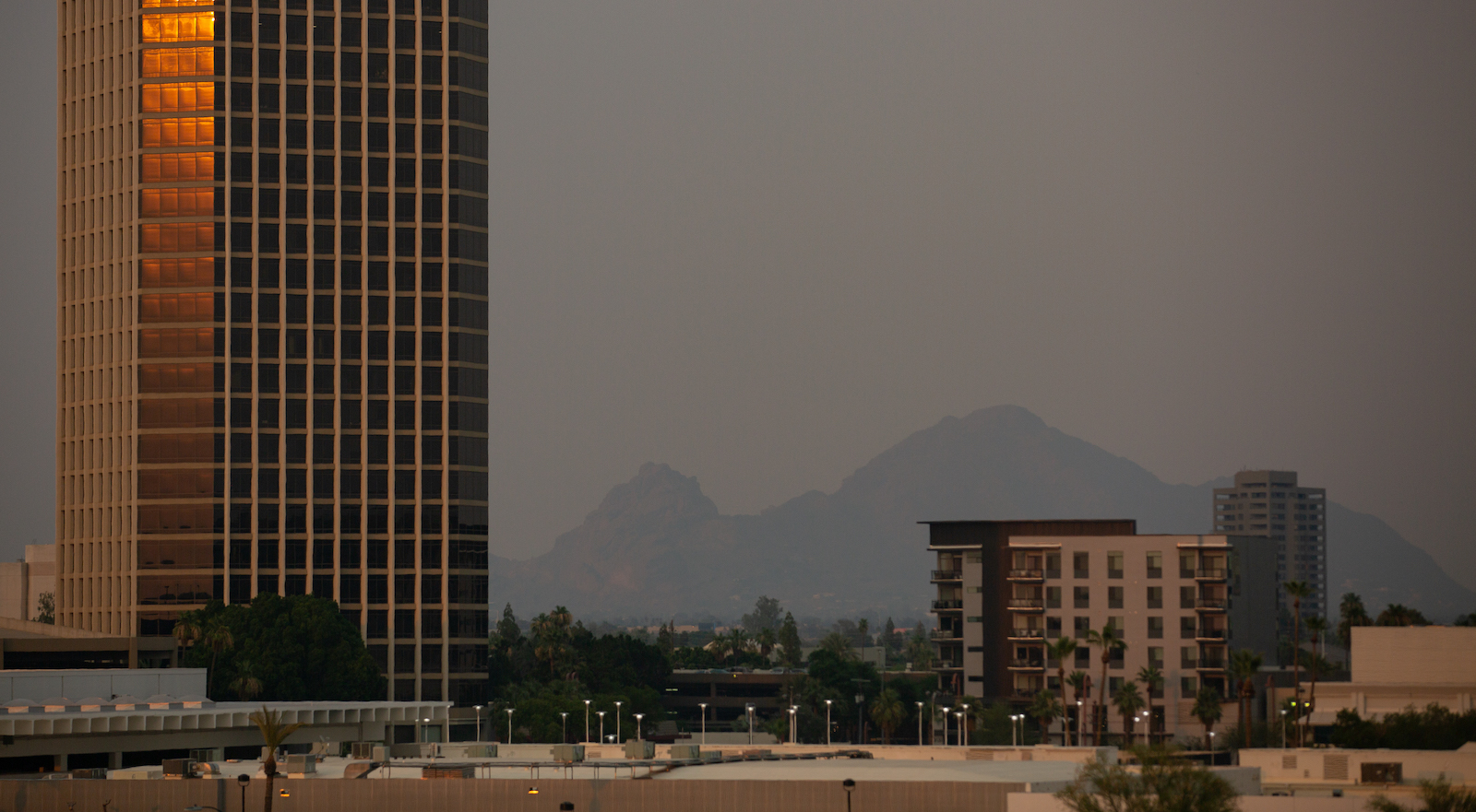 Camelback Mountain is visible through hazy, hot air at sunset on June 15, 2021 in Phoenix, Arizona.