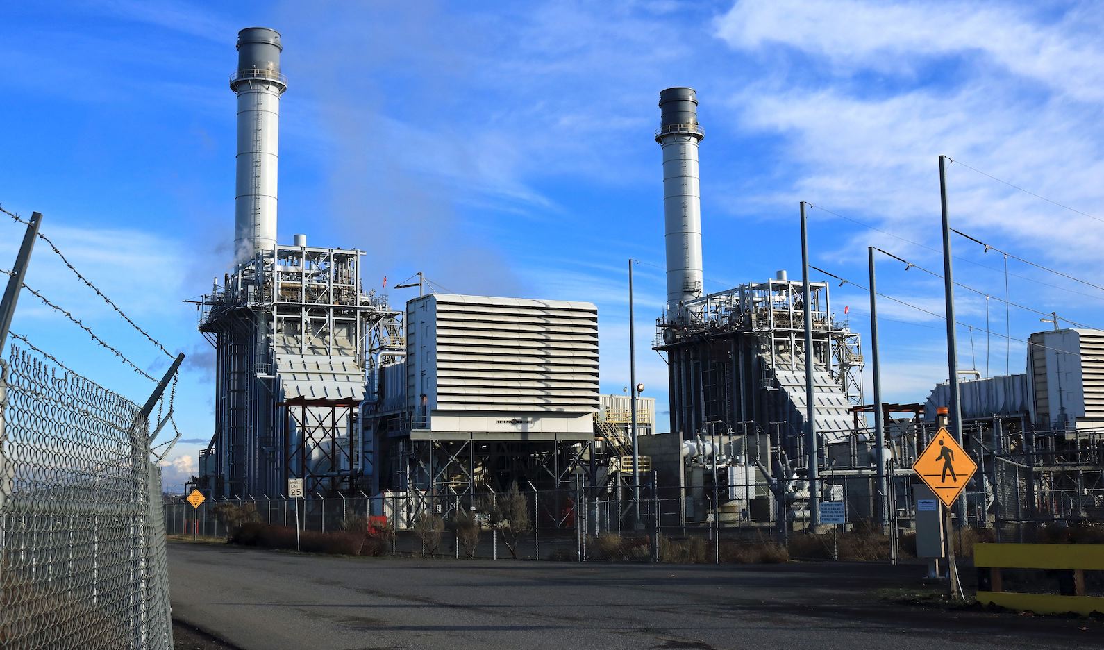 natural gas power plant against a blue sky