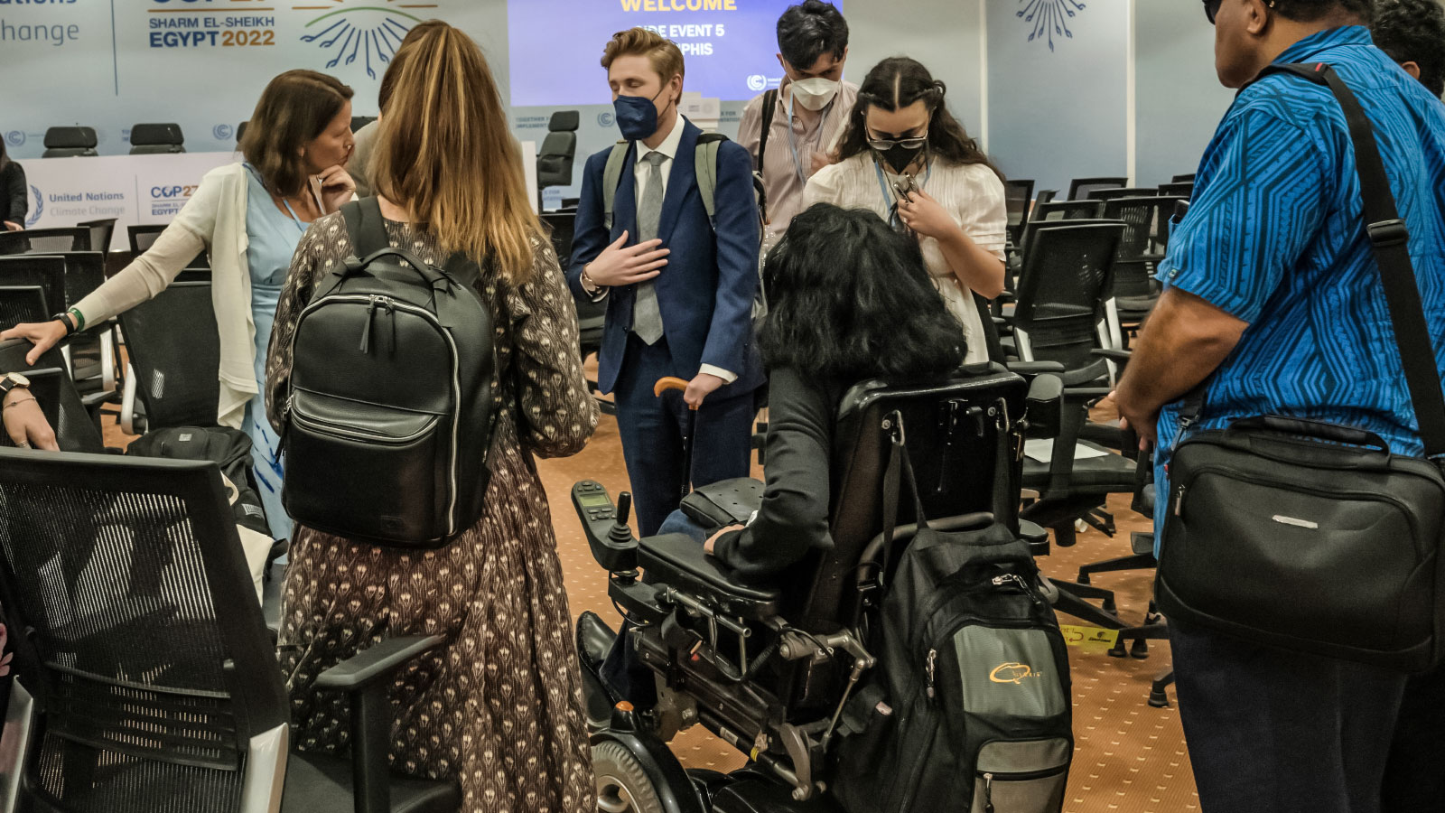 Group of people talking after a panel on climate justice for disabled persons