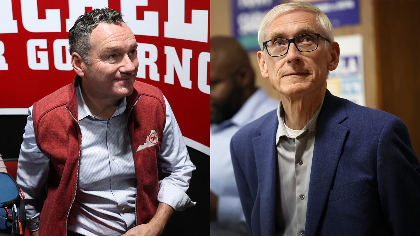 In the left frame, a man with black hair and a red vest smiles, with the right frame shows a man in a blue suit with glasses and white hair smiling as well.