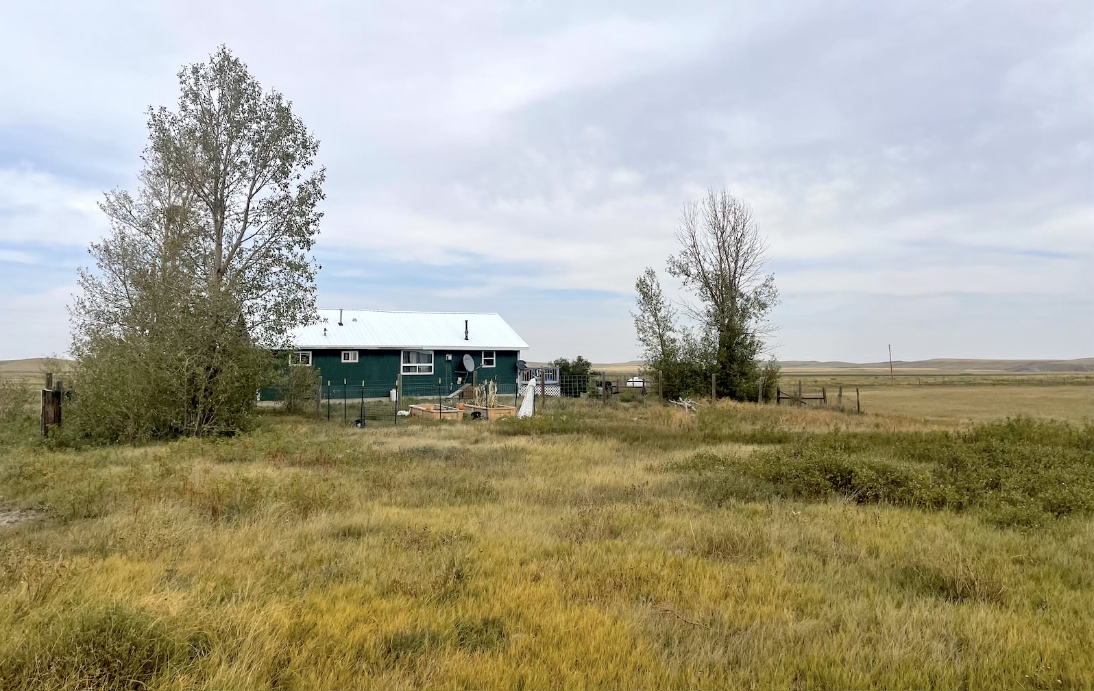 a teal house in a field