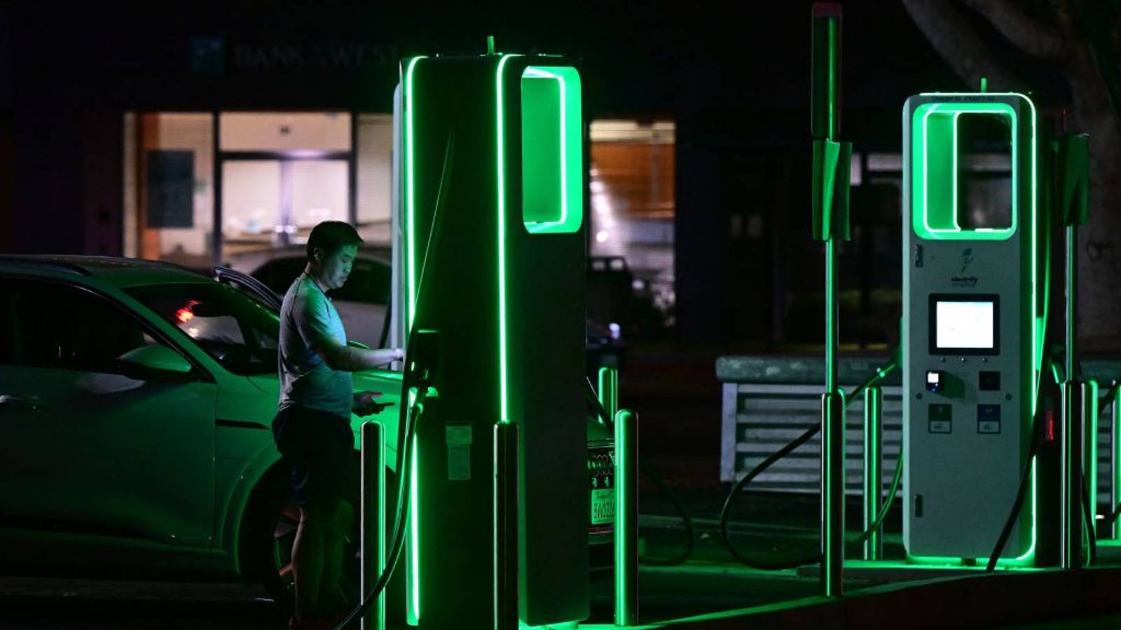 A driver charges his electric vehicle