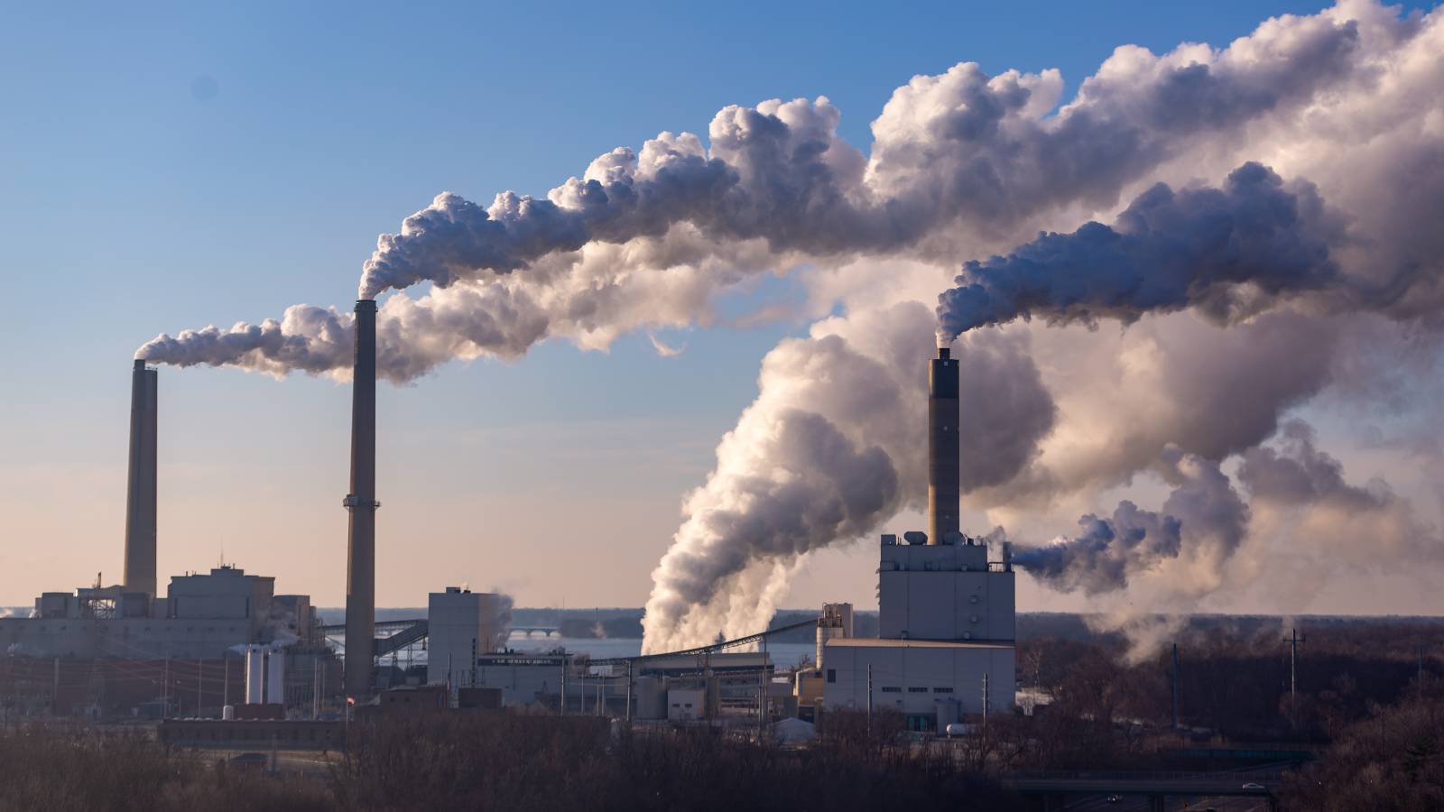 Smoke billows from smoke stacks at coal burning power plant.