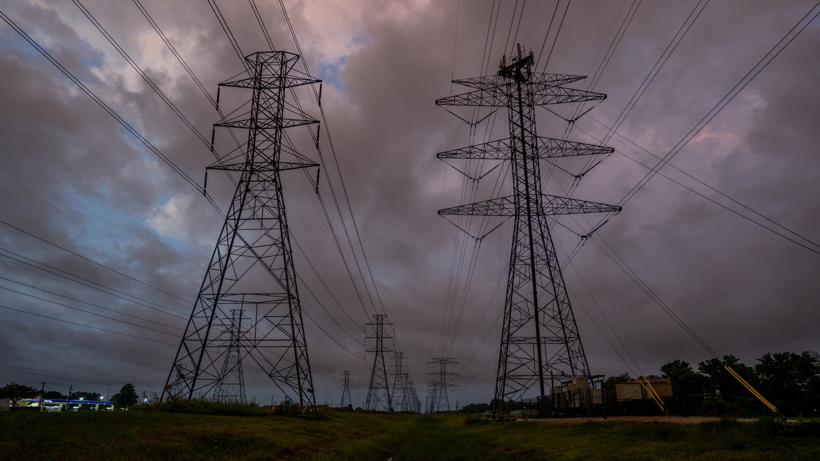 photo of two transition towers against a cloudy evening sky