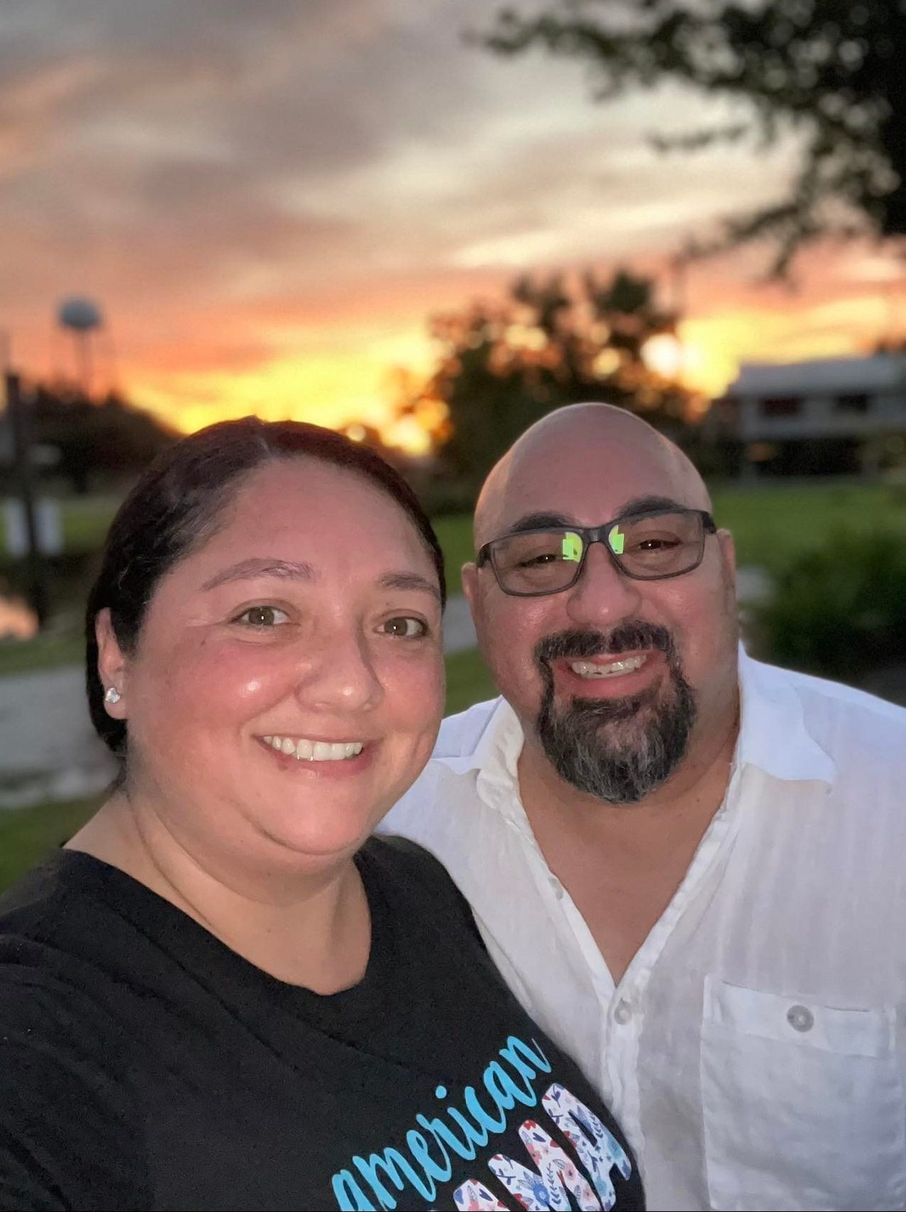 a woman and a man at sunset