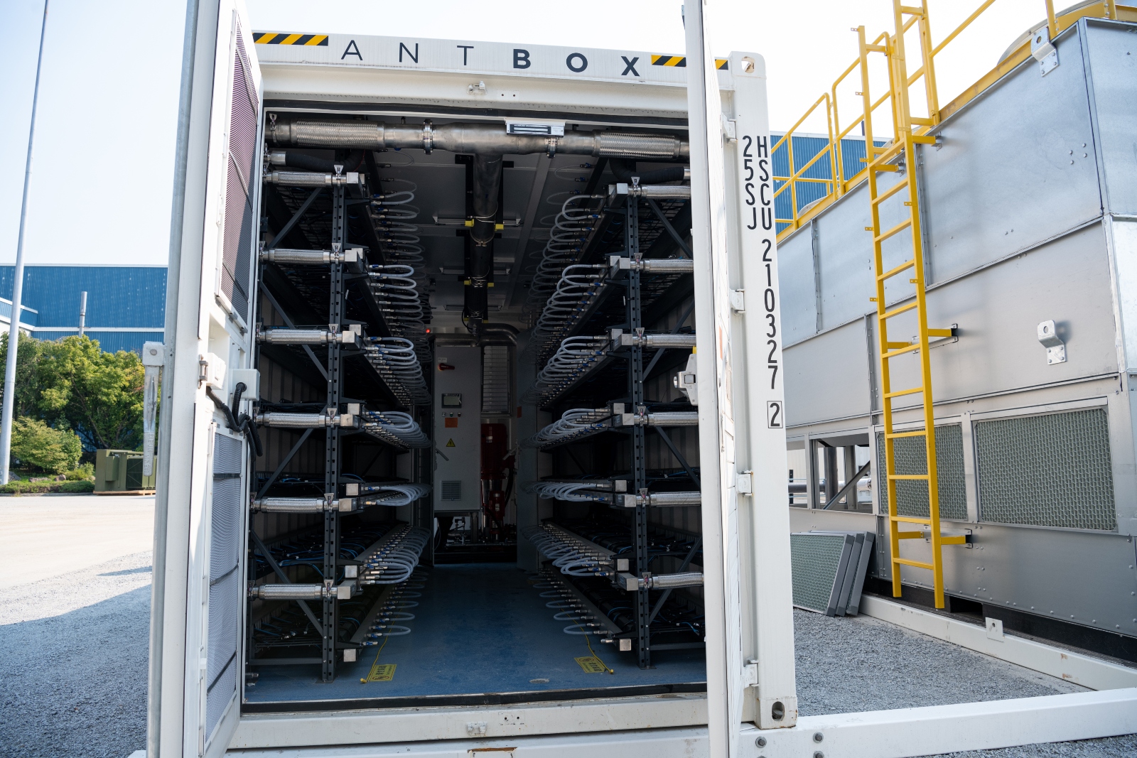 The interior of a white container with the label ANT BOX on top filled with coiled cords.