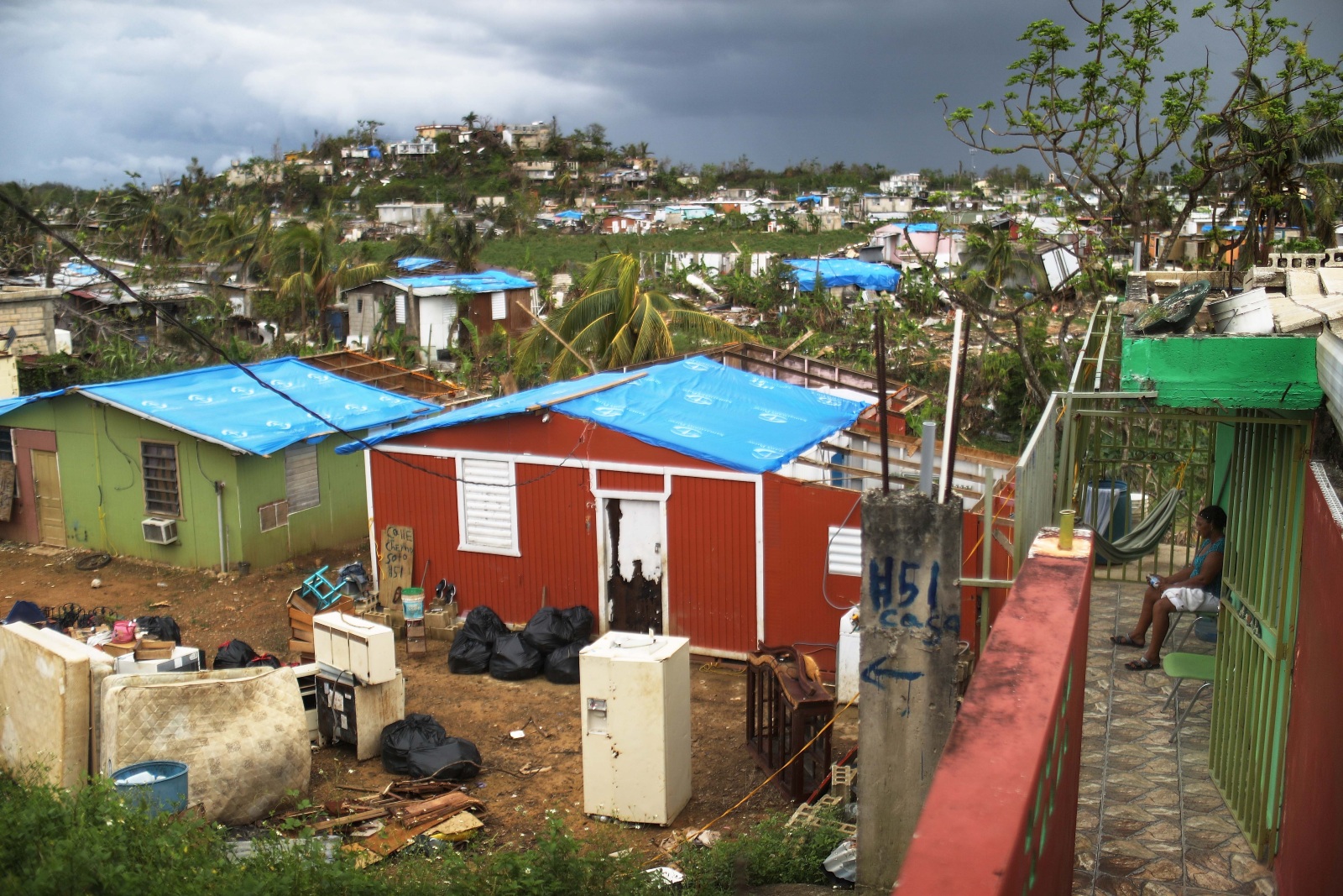 Photo of homes with destroyed doors and roofs