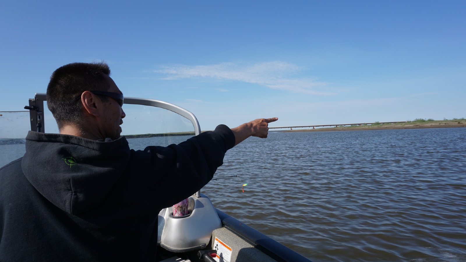 A hunter points out oil development near Nuiqsut, Alaska, in 2019.