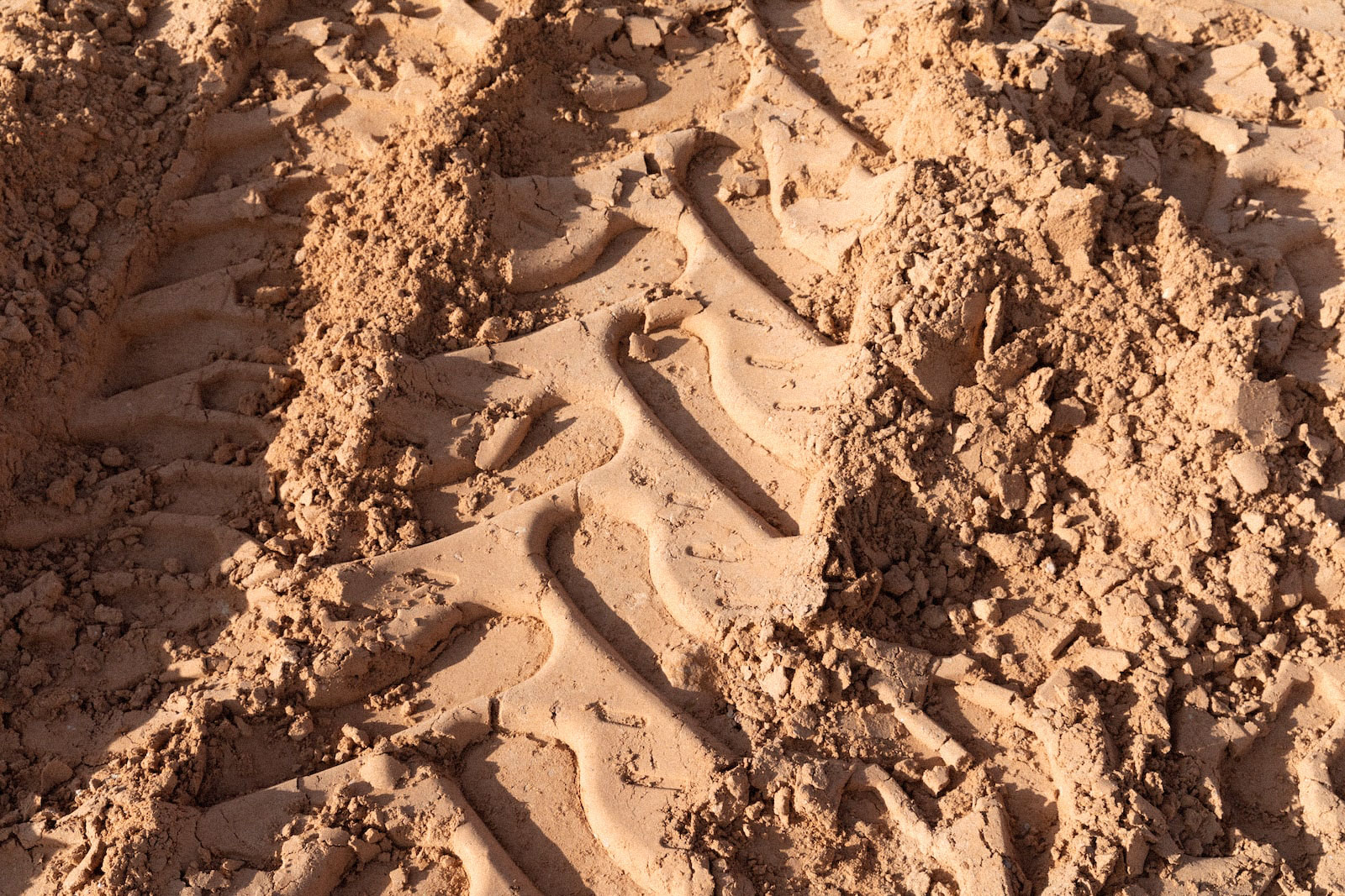 tire tracks in reddish dirt