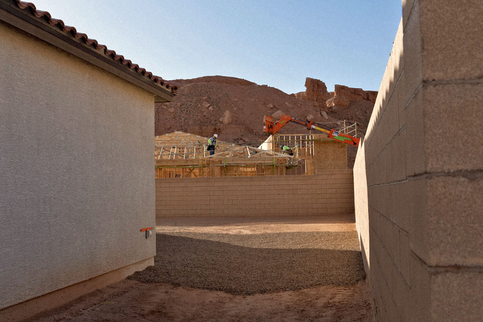 construction workers busy between two new housing units