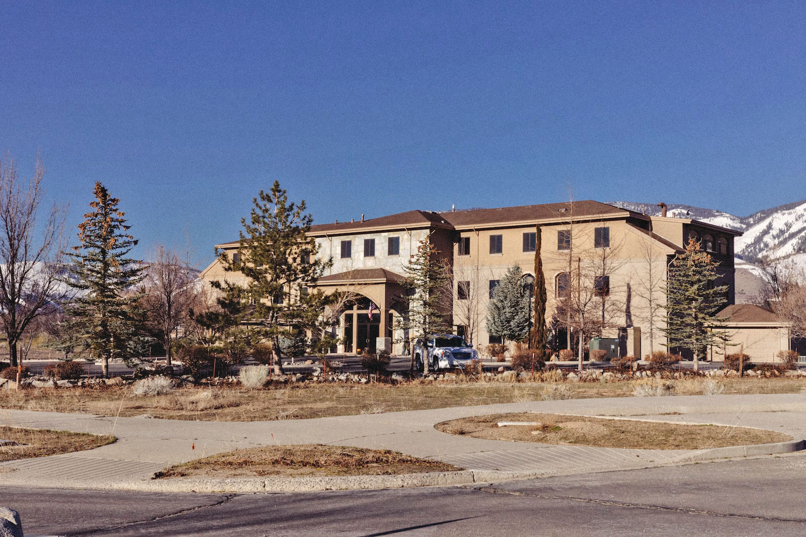 a large mediterranean-style building near mountains