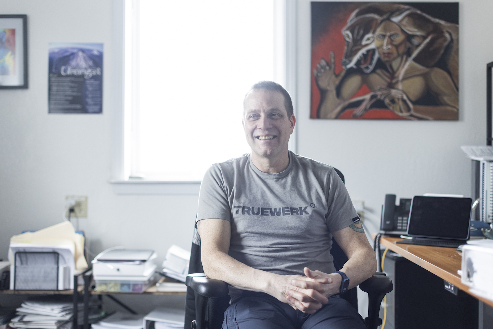 Philip Zavadil sits at a desk in an office