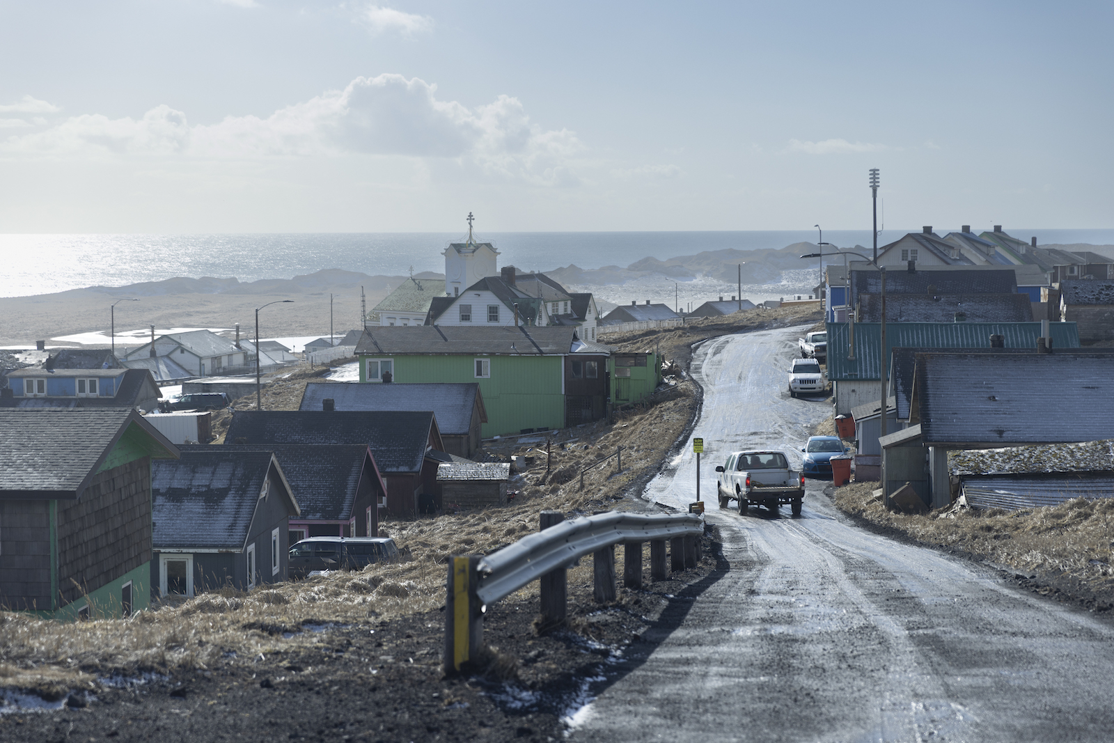 A pickup truck drives along the road in the island community of St. Paul