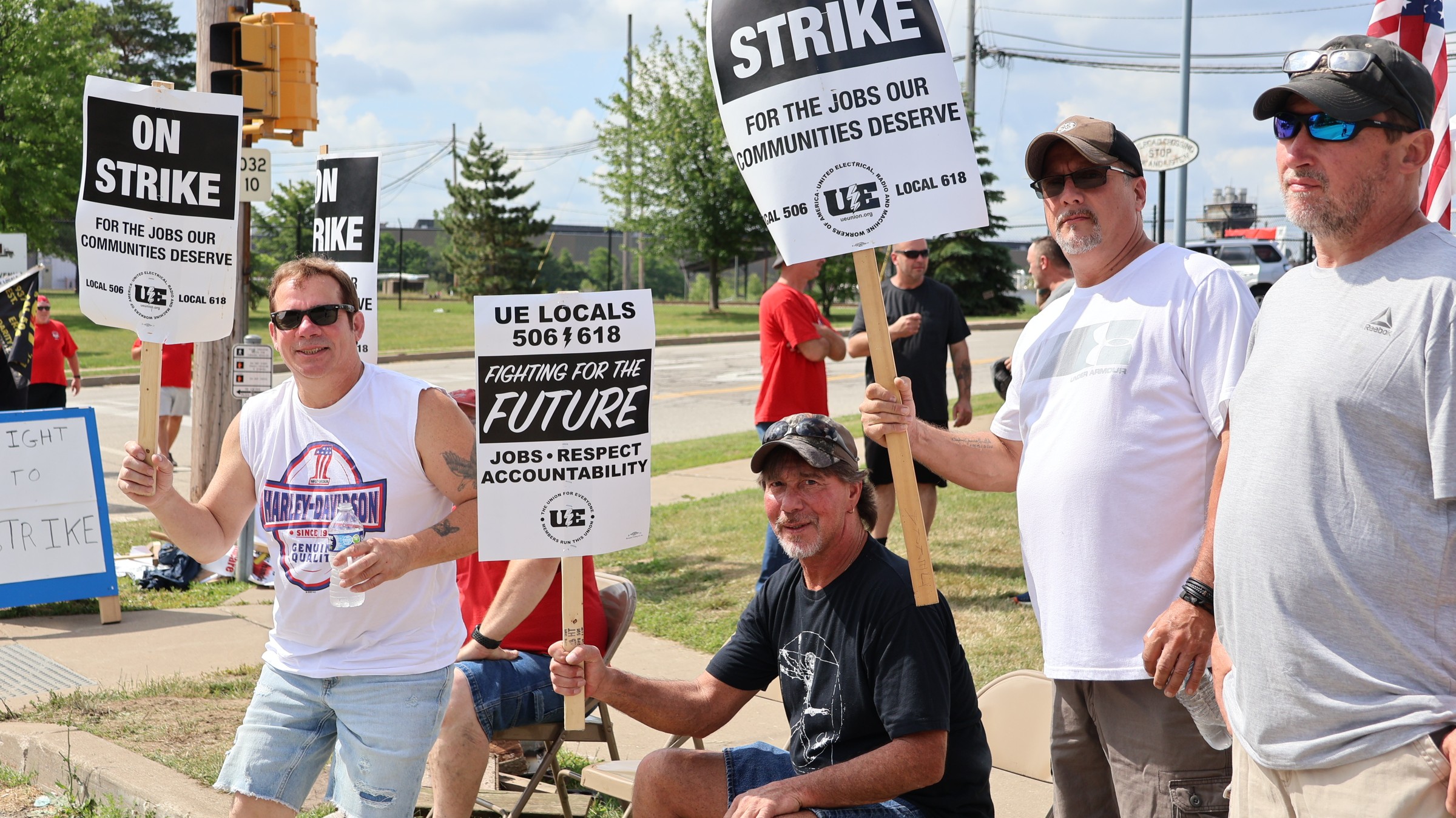 UE workers hold signs reading 'on strike' and 'fighting for the future'