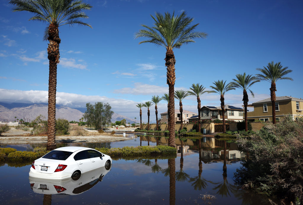 A flooded street with car