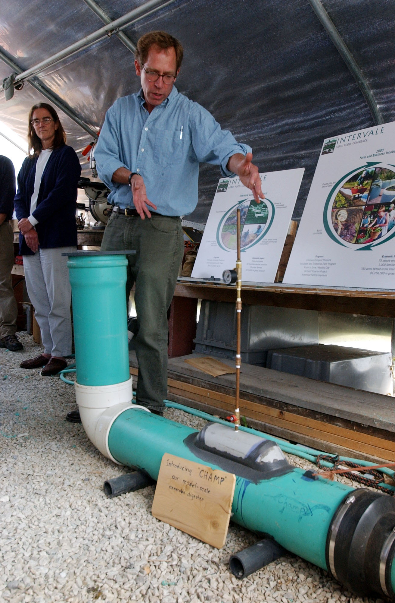 a man shows a diagram next to a green tube