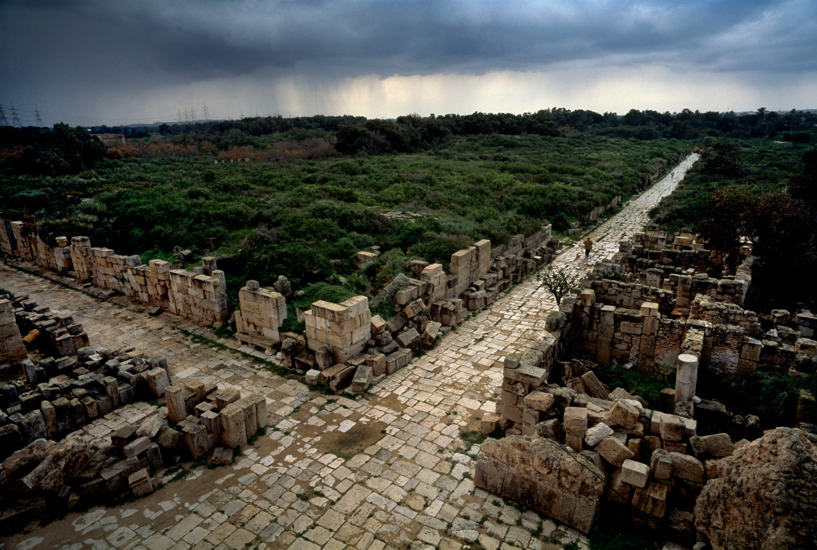 Photo of old roads surrounded by crumbling stone walls.