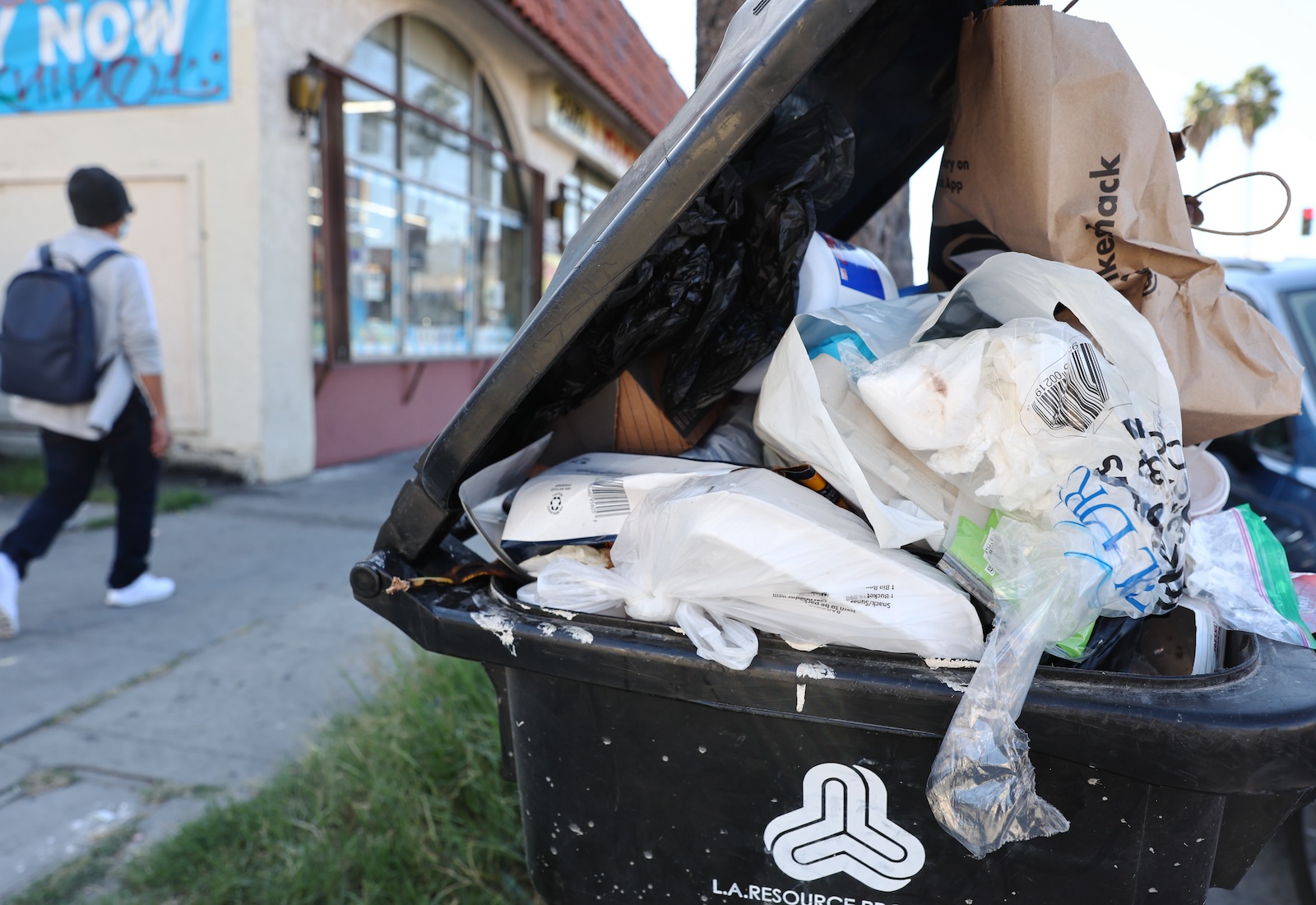 Trash bin overflowing with plastic