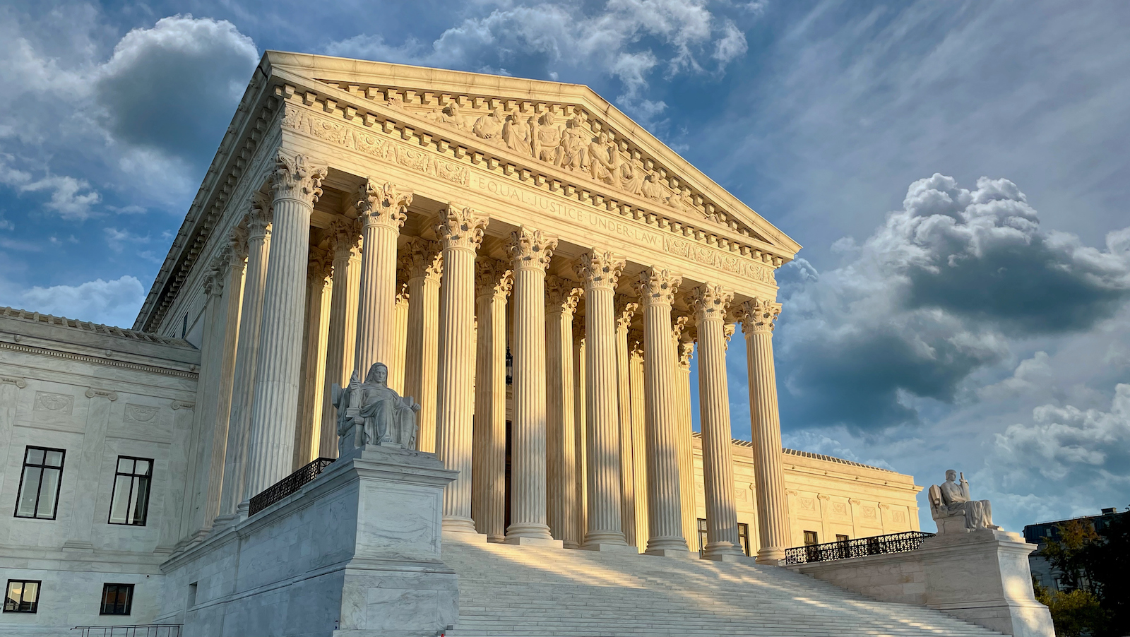 Supreme court building with dramatic clouds above it