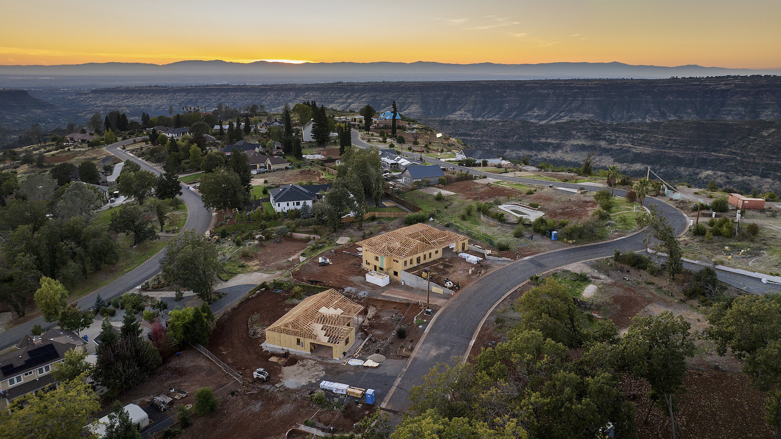 Empty lots, homes under construction and residences built after the Camp Fire line the street.