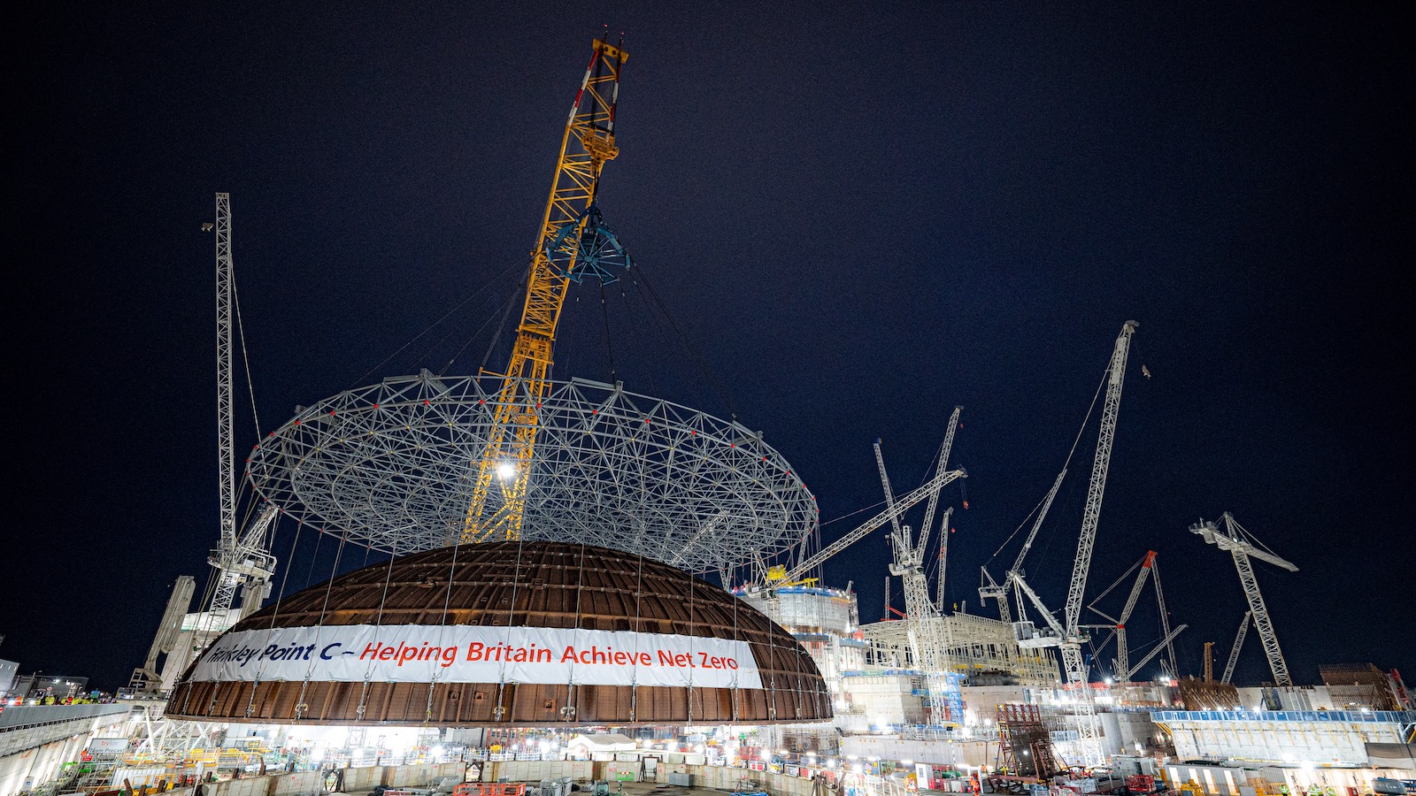 The world's largest crane - nicknamed Big Carl lifts a 245 ton steel dome onto a nuclear reactor under construction in Bridgwater, Somerset, England.