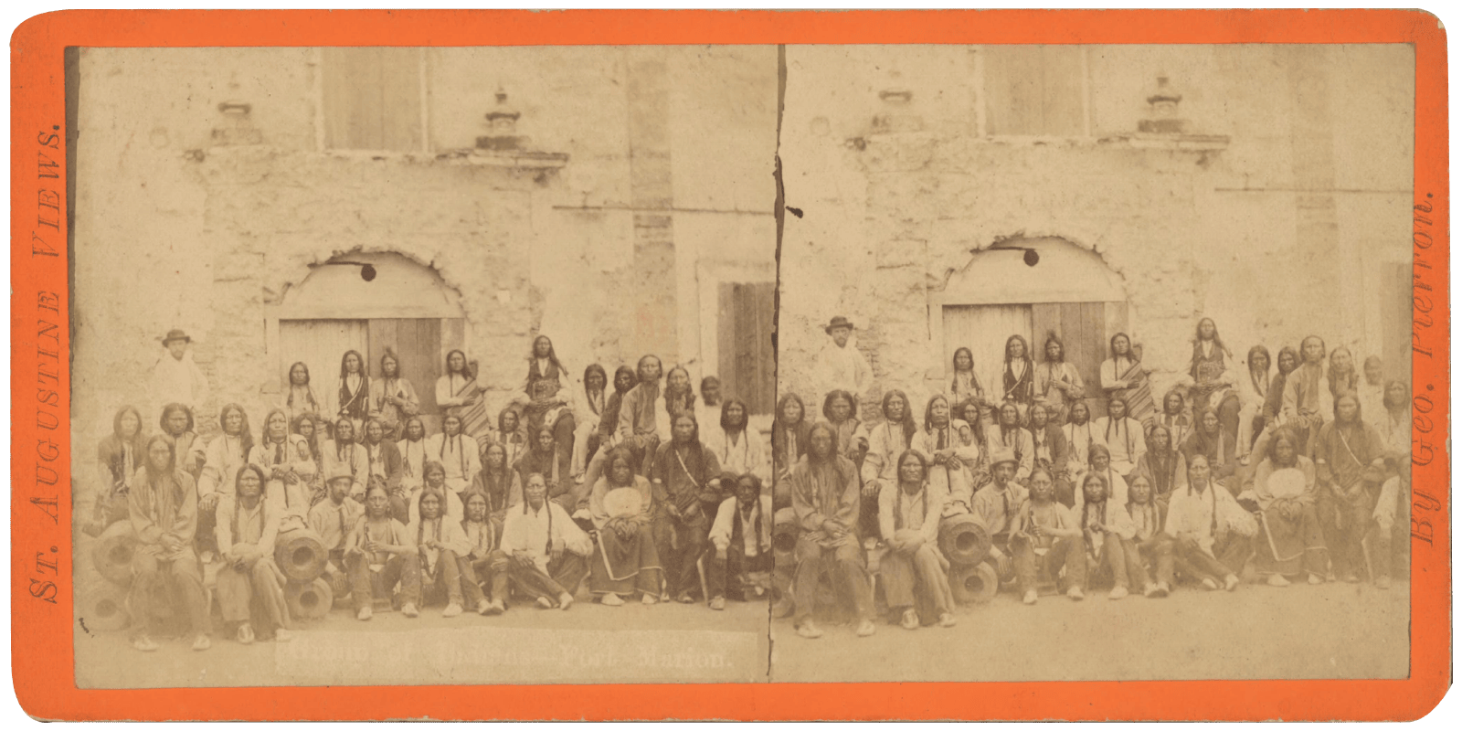 Group portrait of unidentified Native American prisoners of war (likely Kiowa, Southern Cheyenne, Southern Arapaho and/or Caddo Indians) involved in the Red River War being held at Fort Marion in Saint Augustine, Florida. An unidentified white American man appears at left.