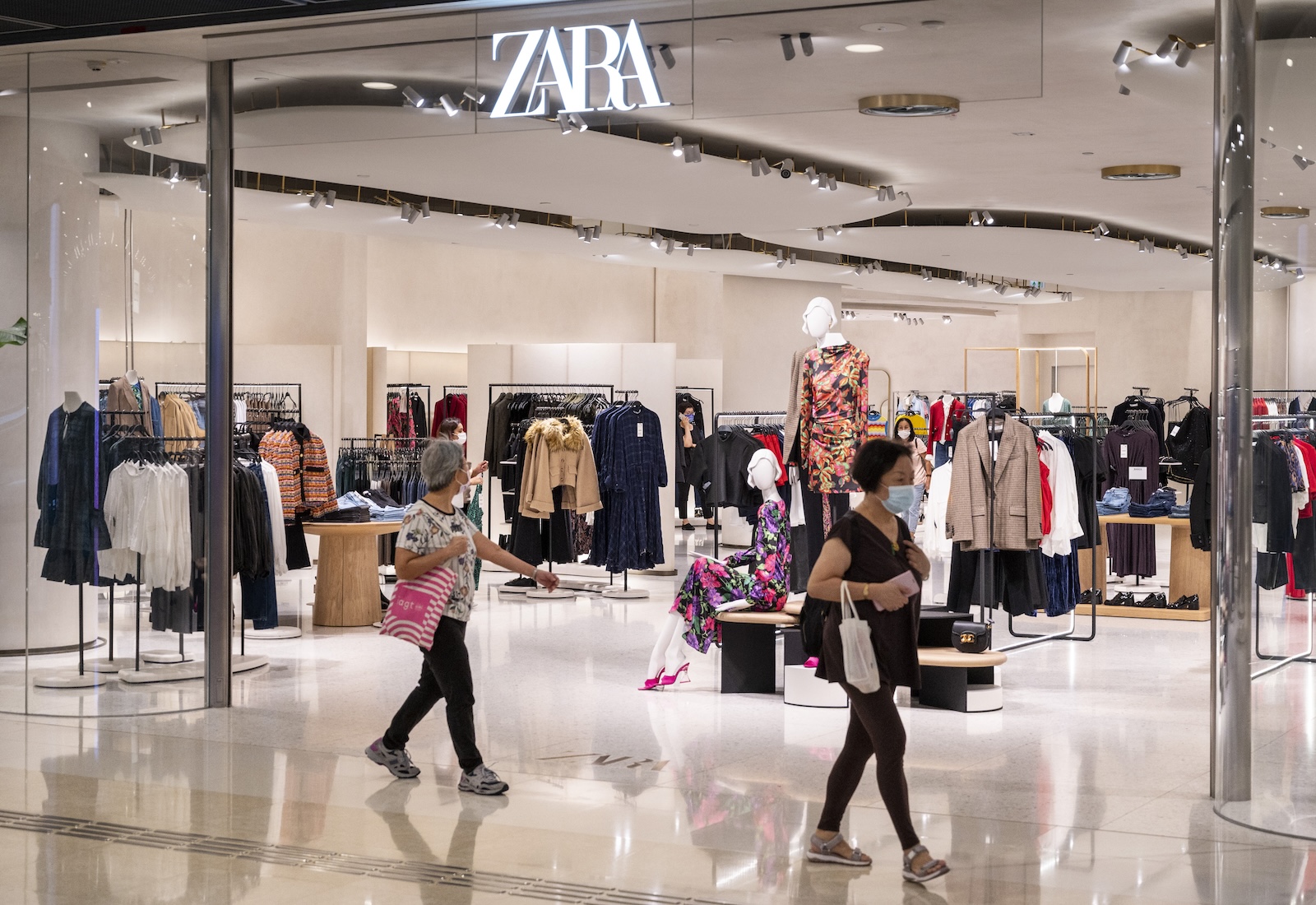 Zara storefront with people walking in front