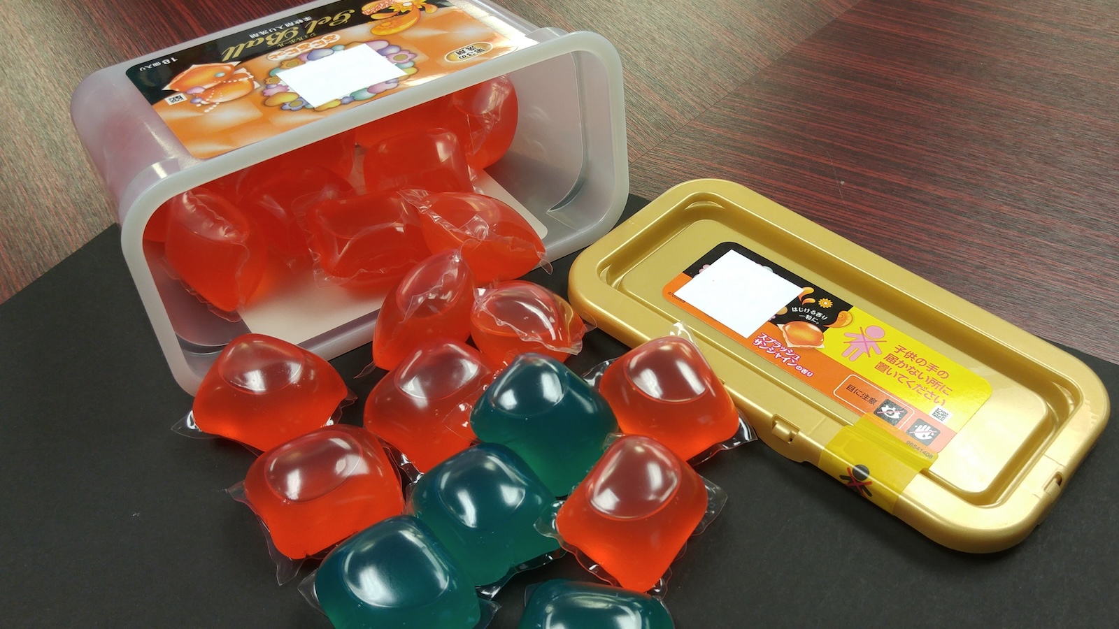 Laundry detergent pods spilling from a container.