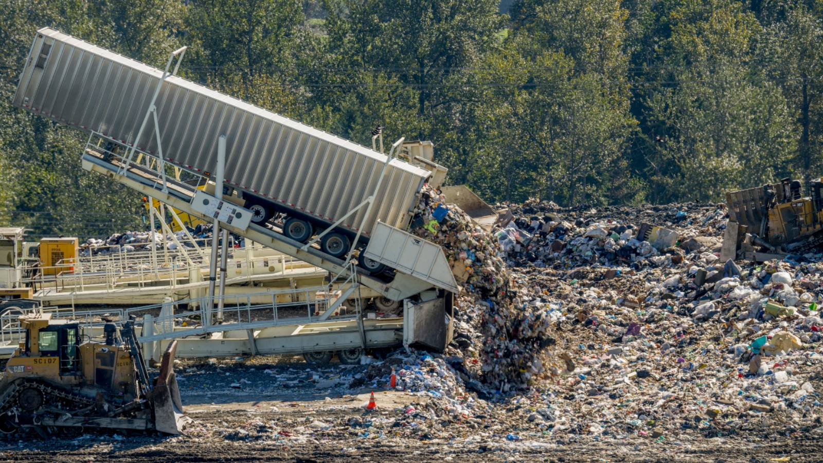 Trailer tipping garbage into dump