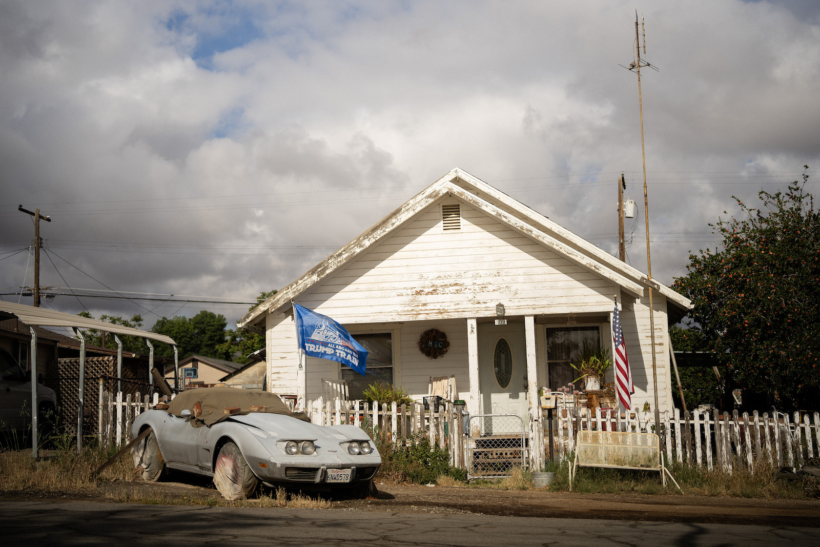 A house with a blue flag that says 'trump train'