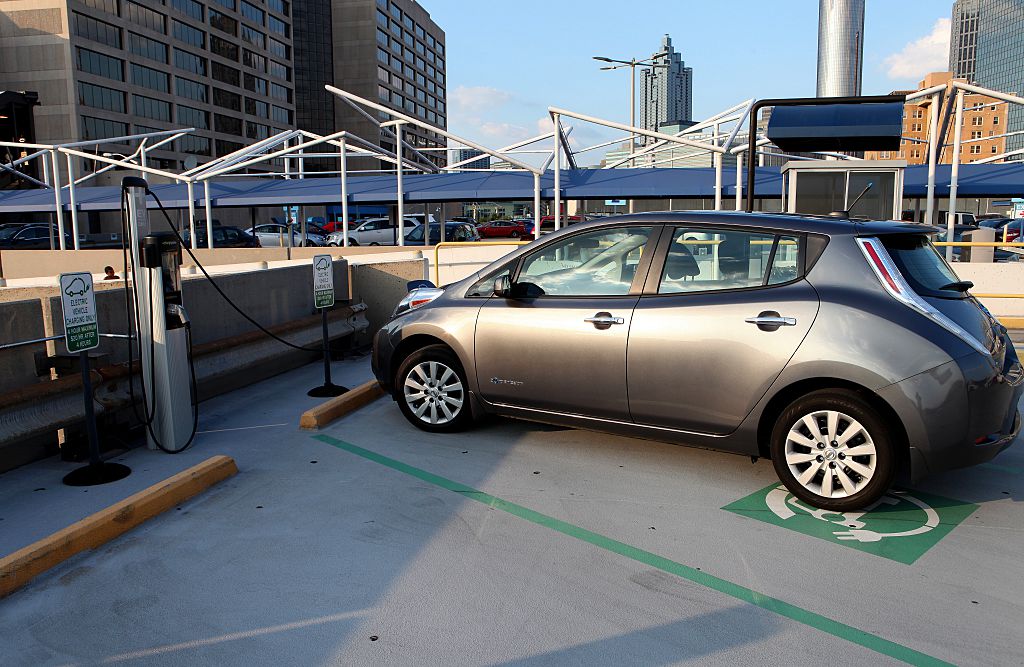 A silver car is parked at an electric vehicle charging station in Atlanta, Georgia.