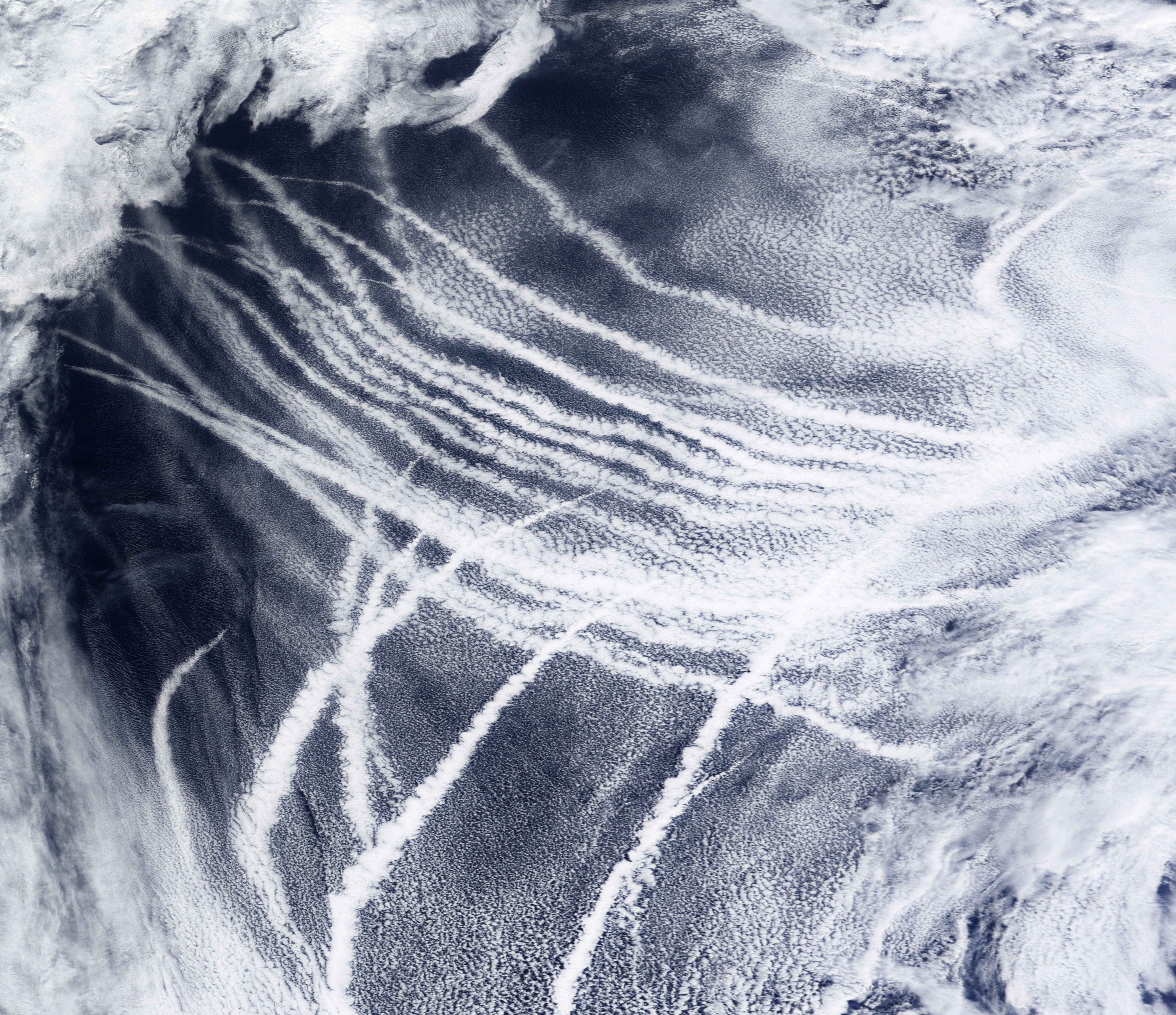 A satellite image showing clouds formed by ship tracks streaking across the North Pacific