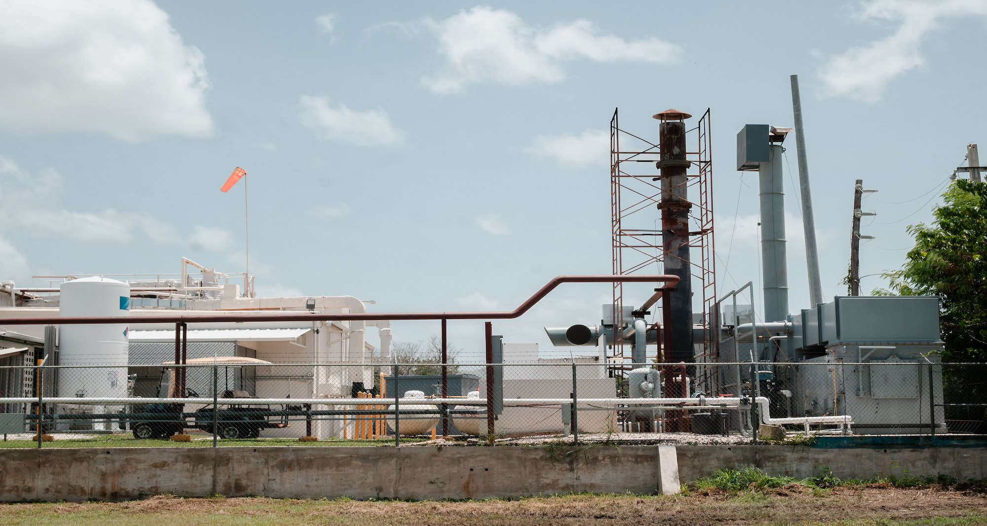 A large pipe coming out of the ground surrounded by scaffolding