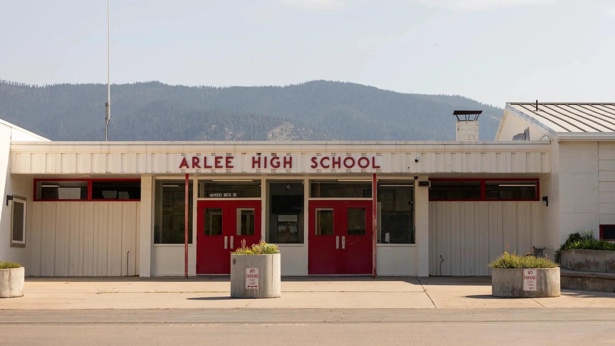 A one-story building with a sight that says 'arlee high school'