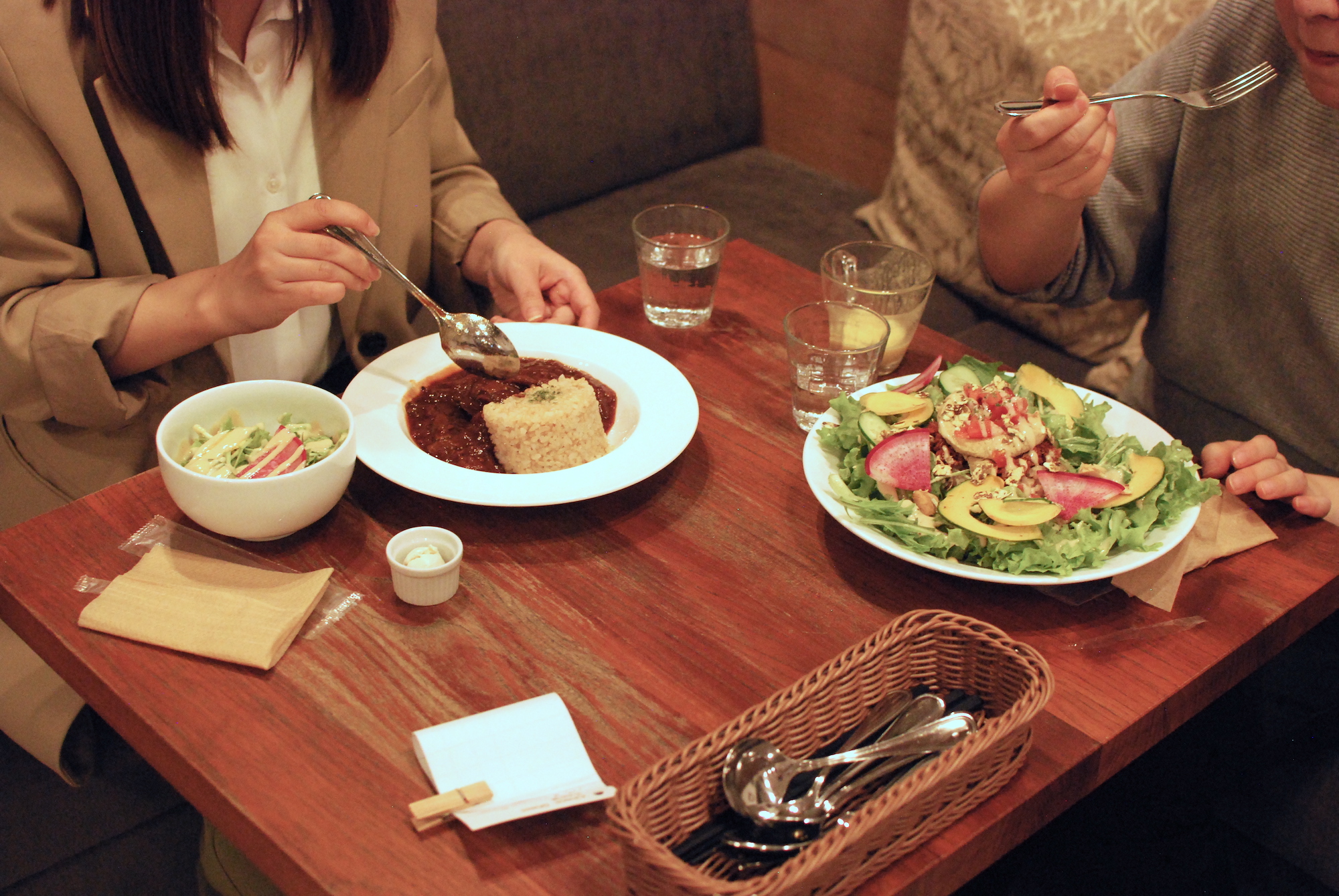 People sit at a table eating lunch